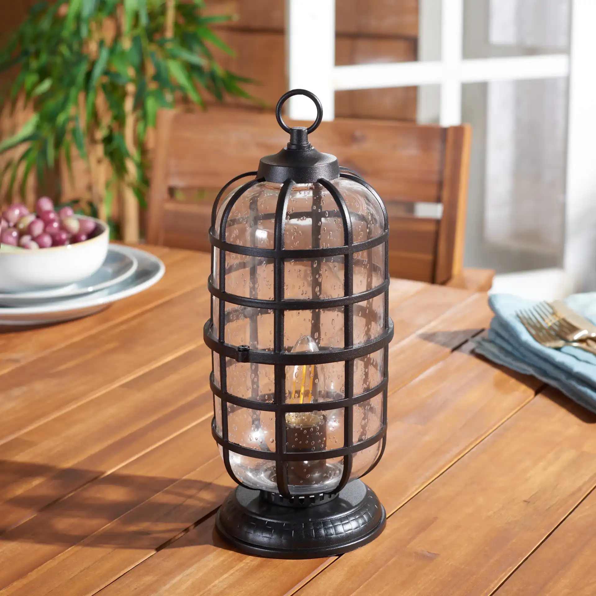 Rigel Outdoor Table Lamp in Black in a styled room
