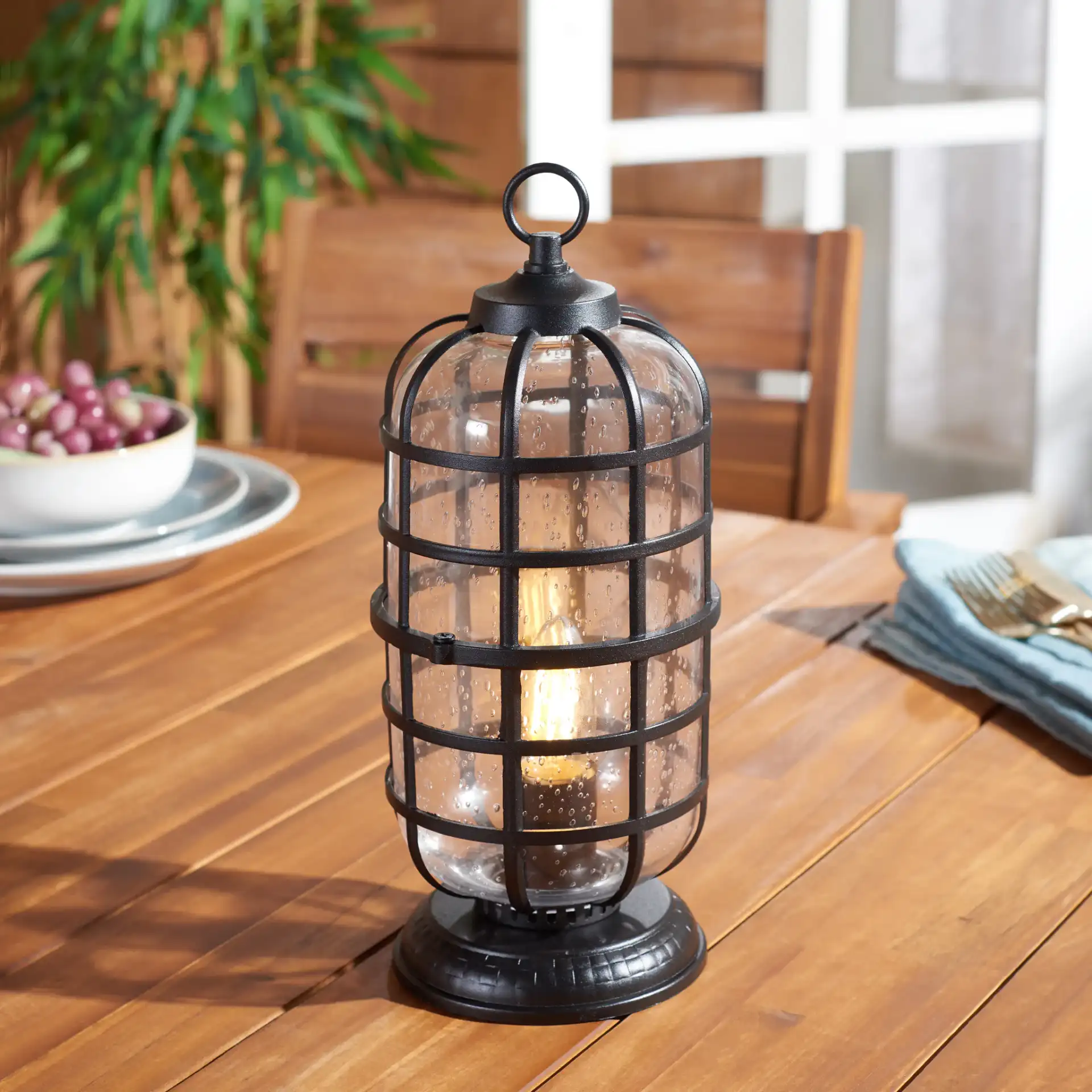 Rigel Outdoor Table Lamp in Black in a styled room