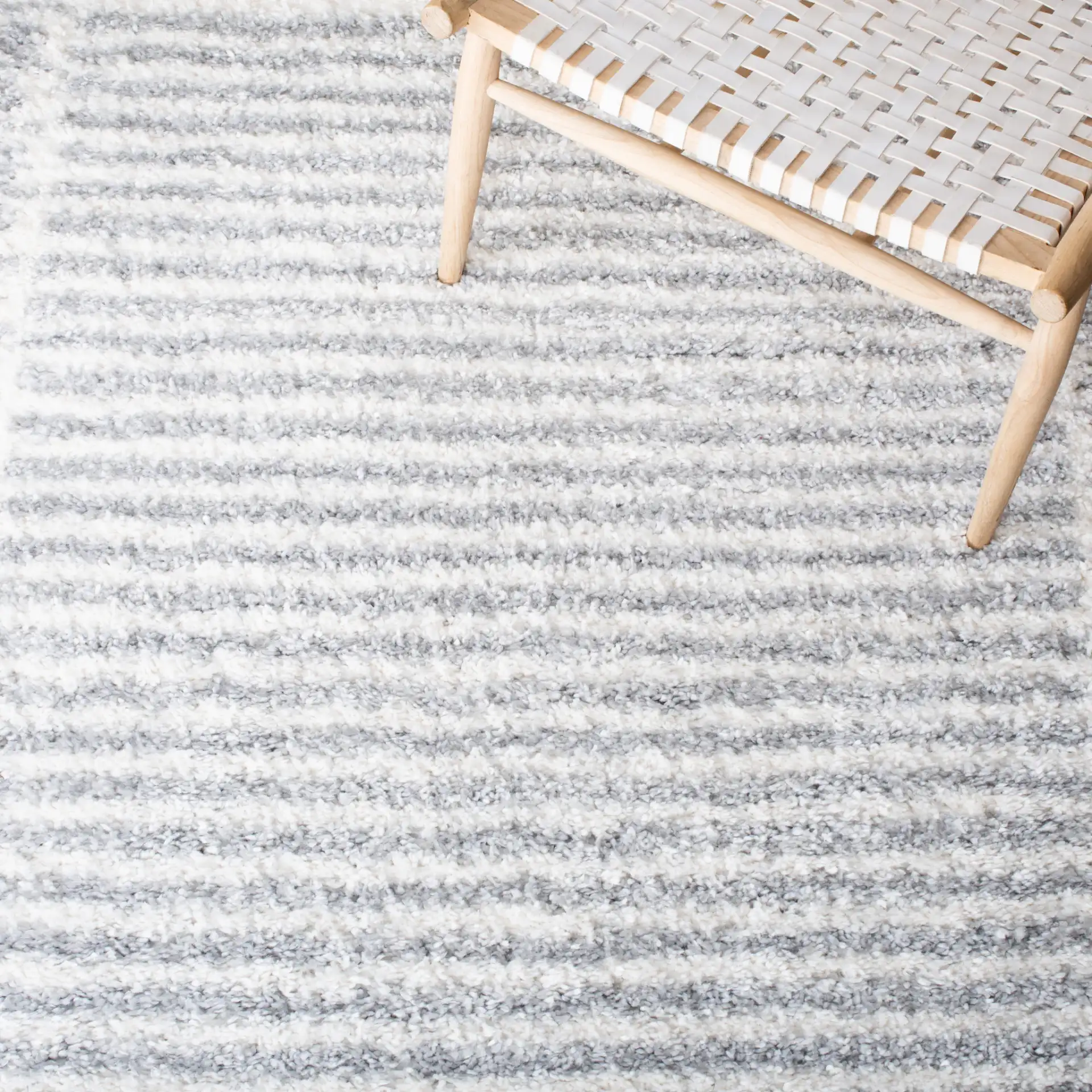 Parma Striped Border Shag Rug in Gray / Ivory in a styled room