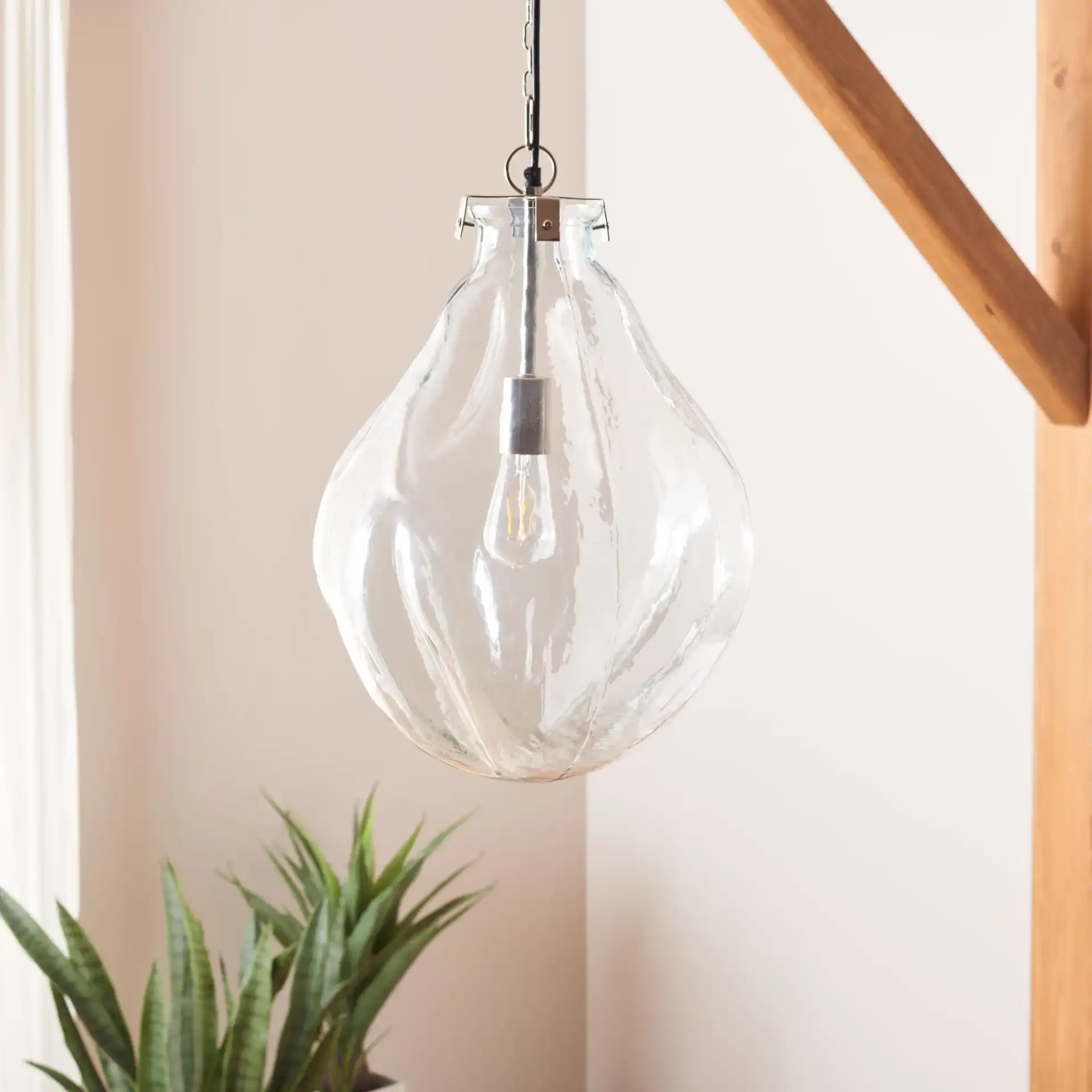 Kinney Pendant in Clear / Nickel in a styled room