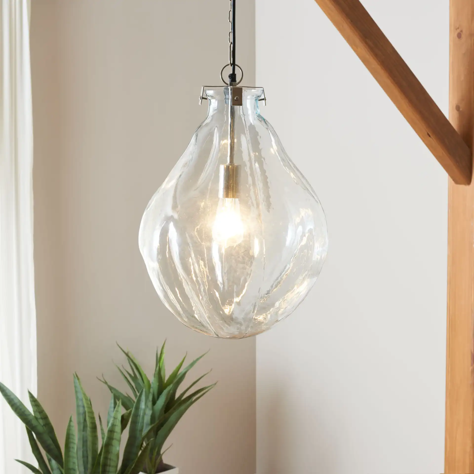 Kinney Pendant in Clear / Nickel in a styled room