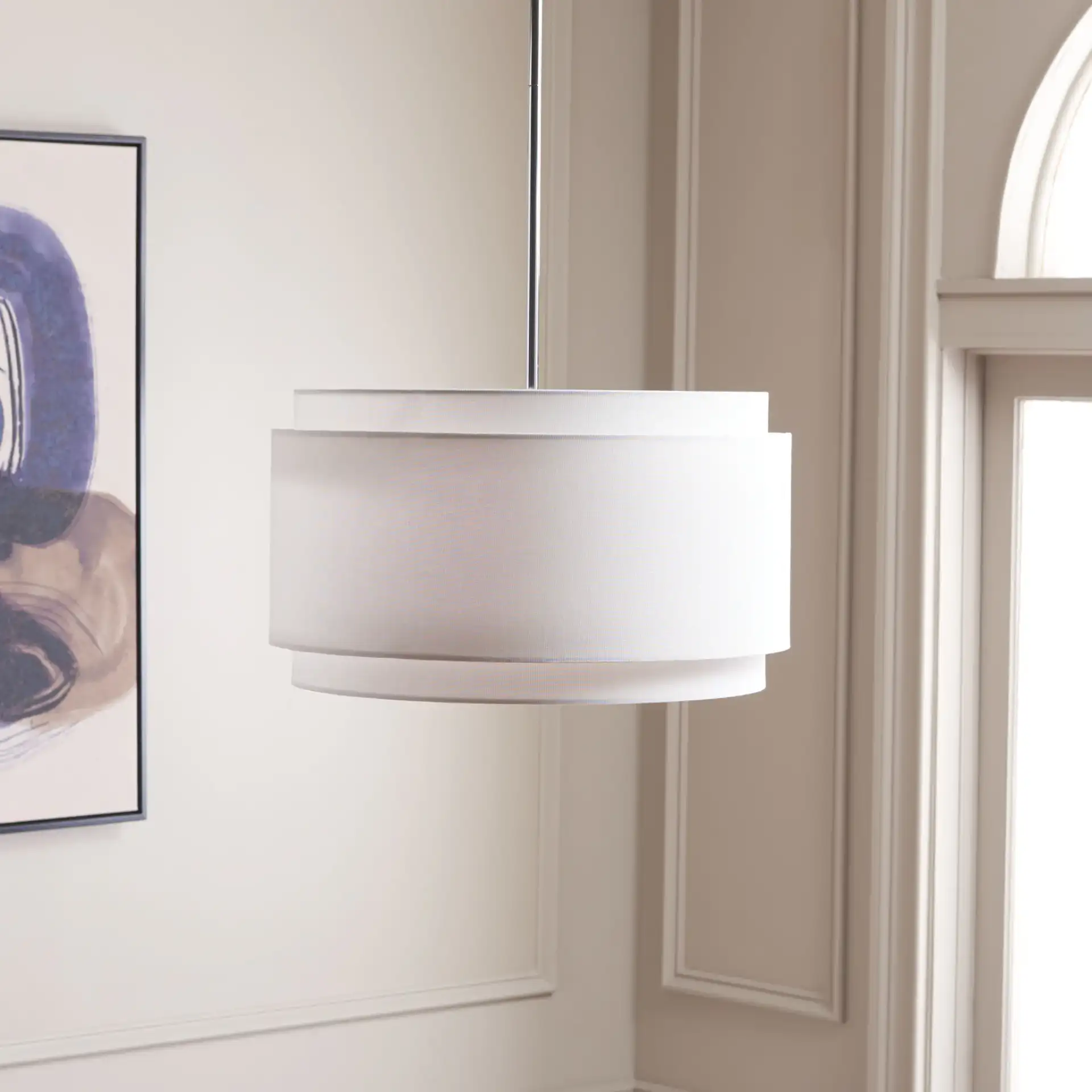 Piran Three-Light Pendant in Chrome / White in a styled room