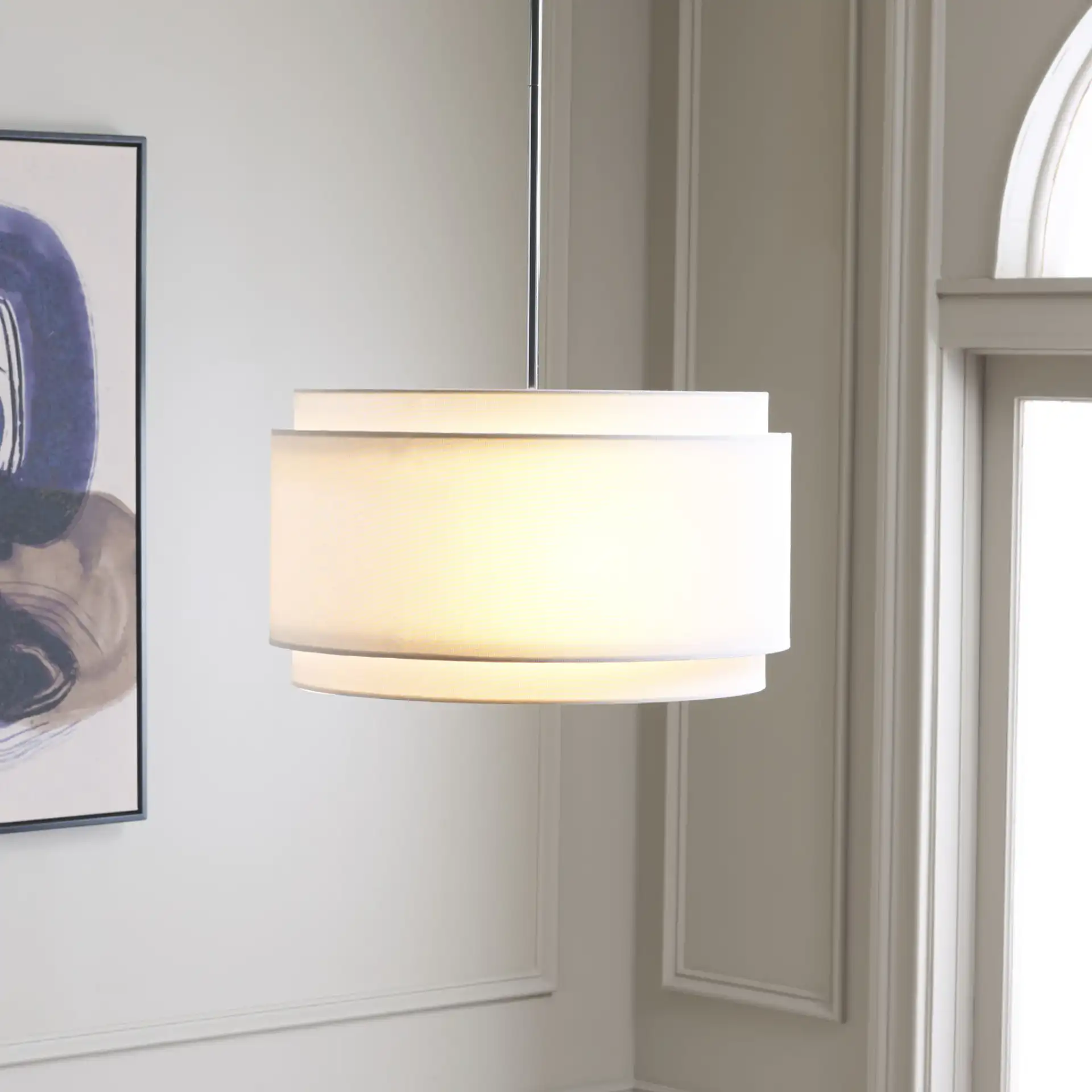 Piran Three-Light Pendant in Chrome / White in a styled room