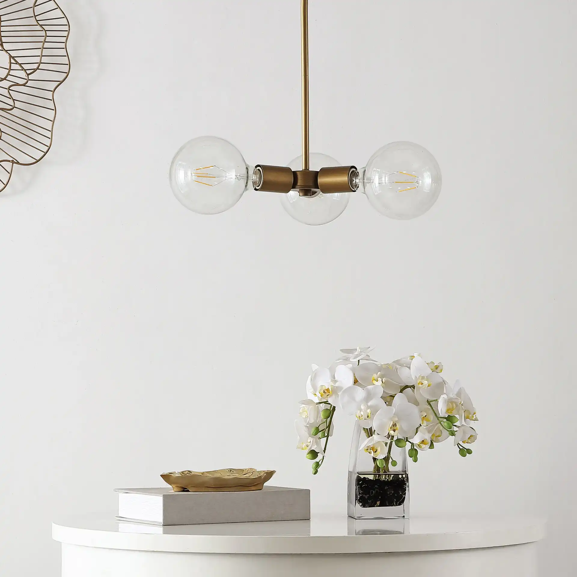 Harkin Three-Light Pendant in Gold in a styled room