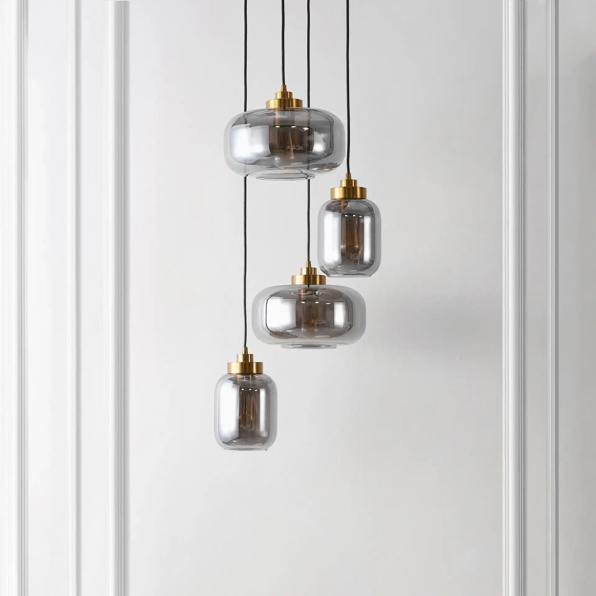 Equinox Four-Light Pendant in Smoke Gray / Brass in a styled room