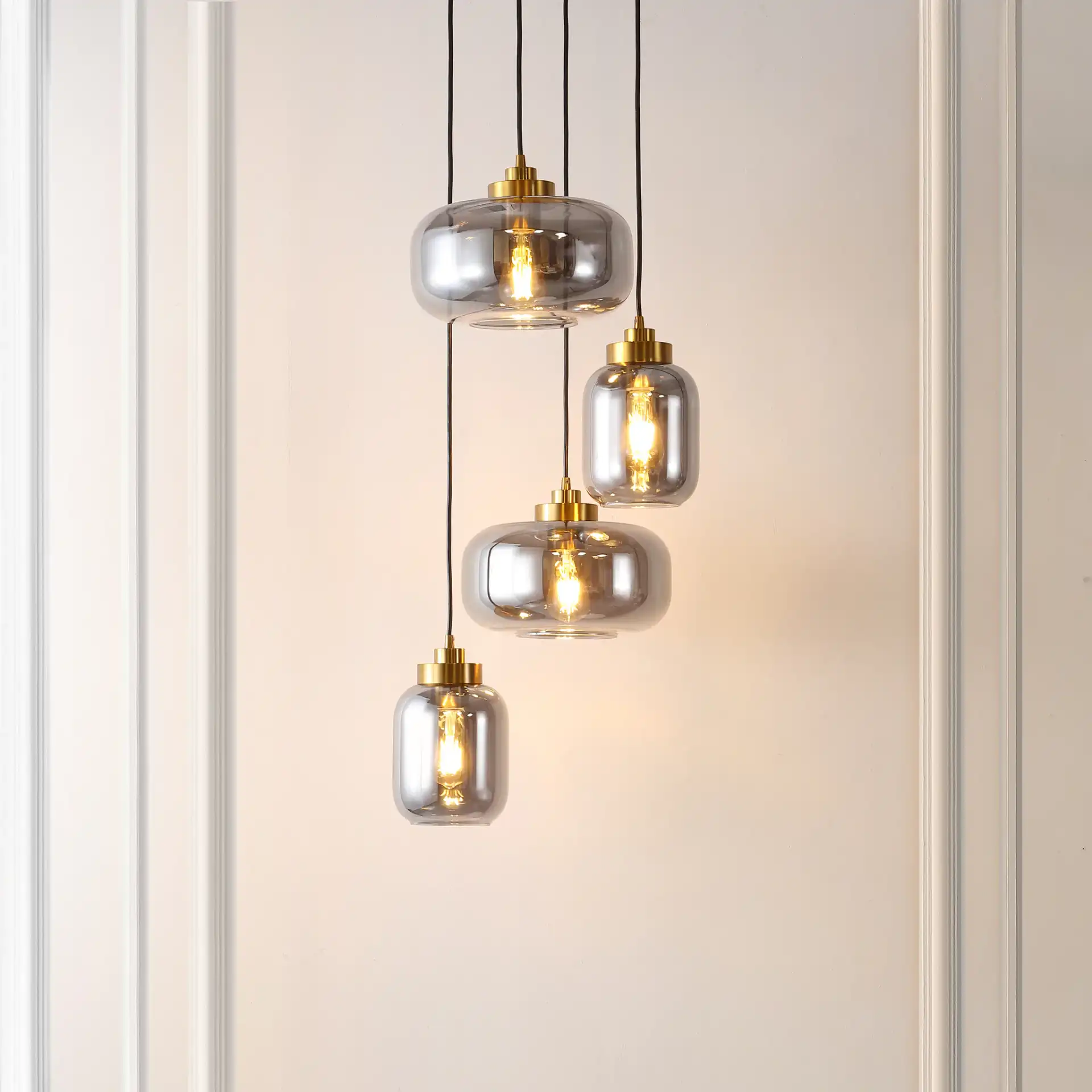 Equinox Four-Light Pendant in Smoke Gray / Brass in a styled room