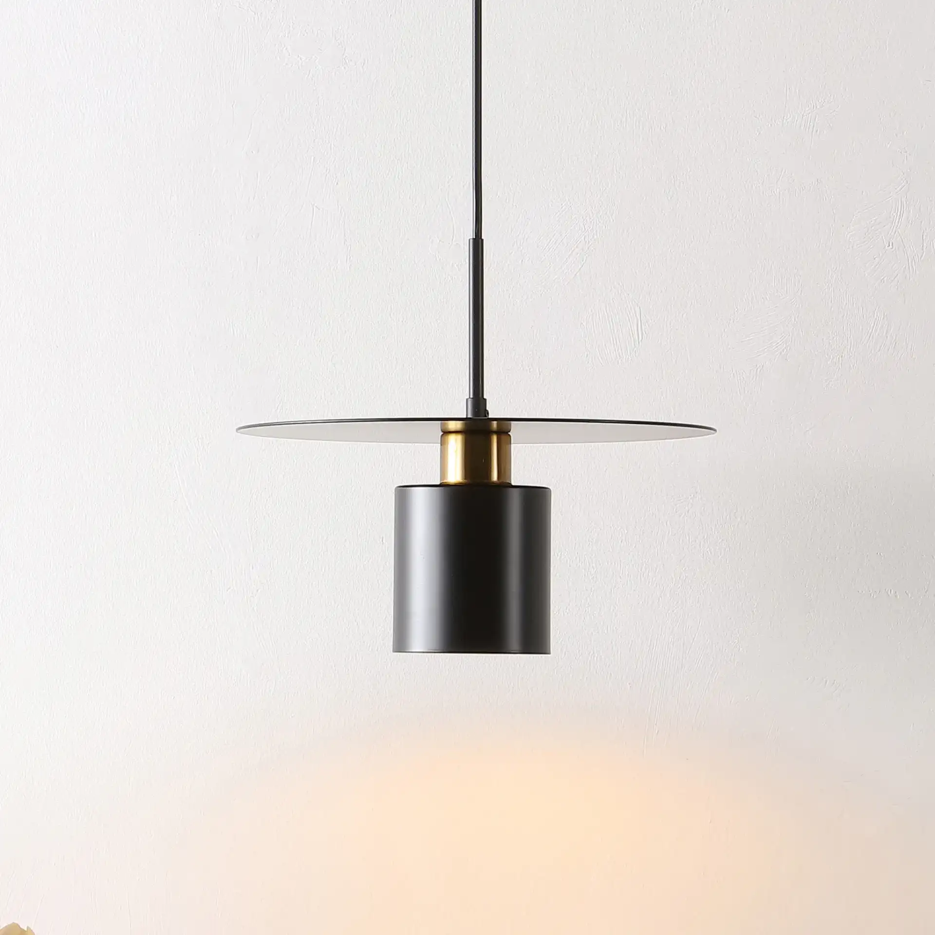 Mynoby Pendant in Black / Brass in a styled room