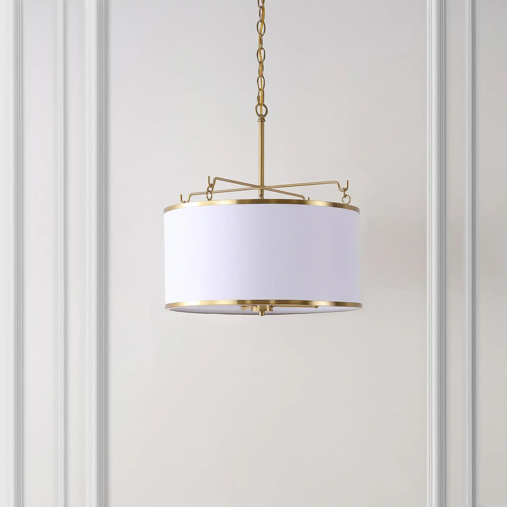 Perzeta Three-Light Pendant in Brass / White in a styled room