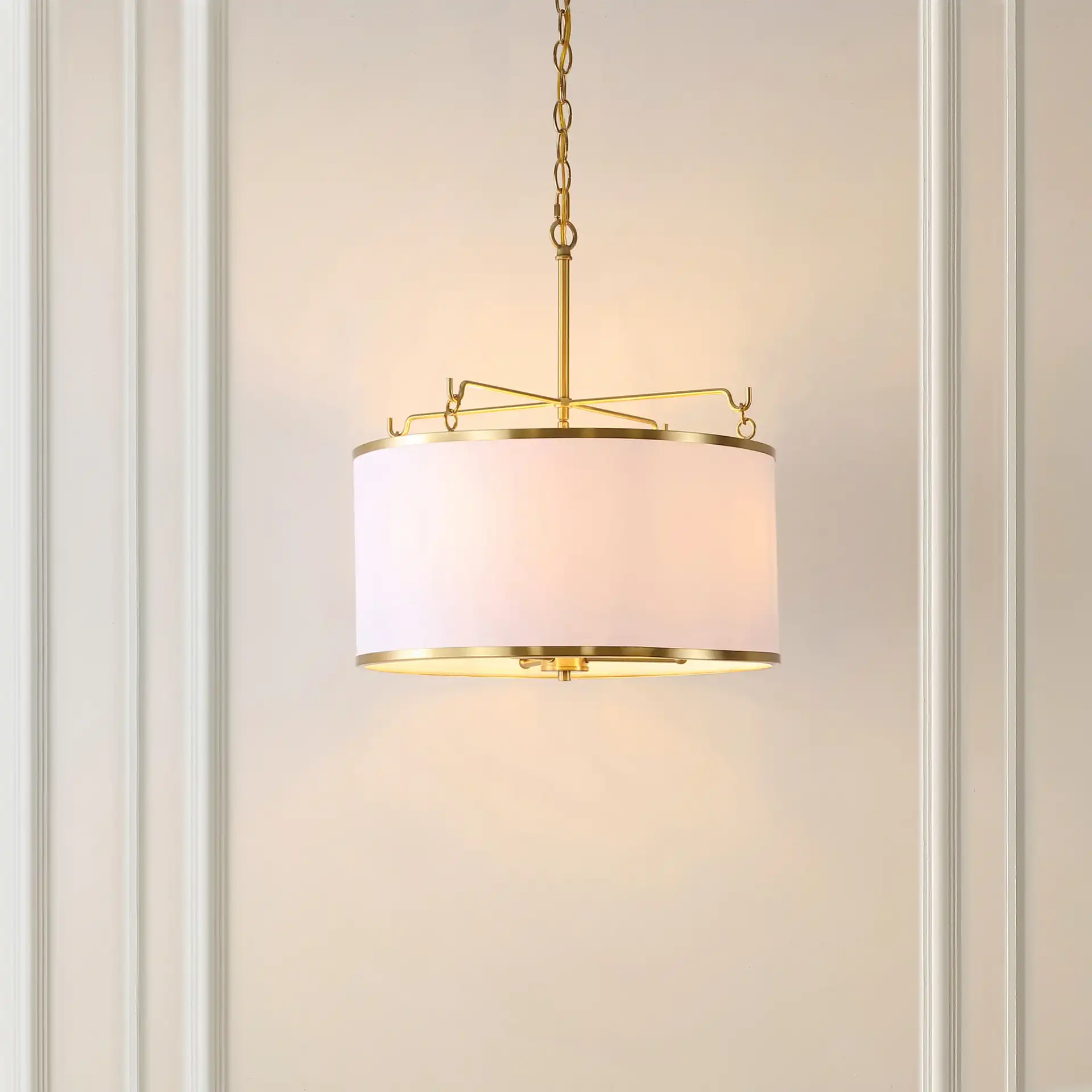 Perzeta Three-Light Pendant in Brass / White in a styled room