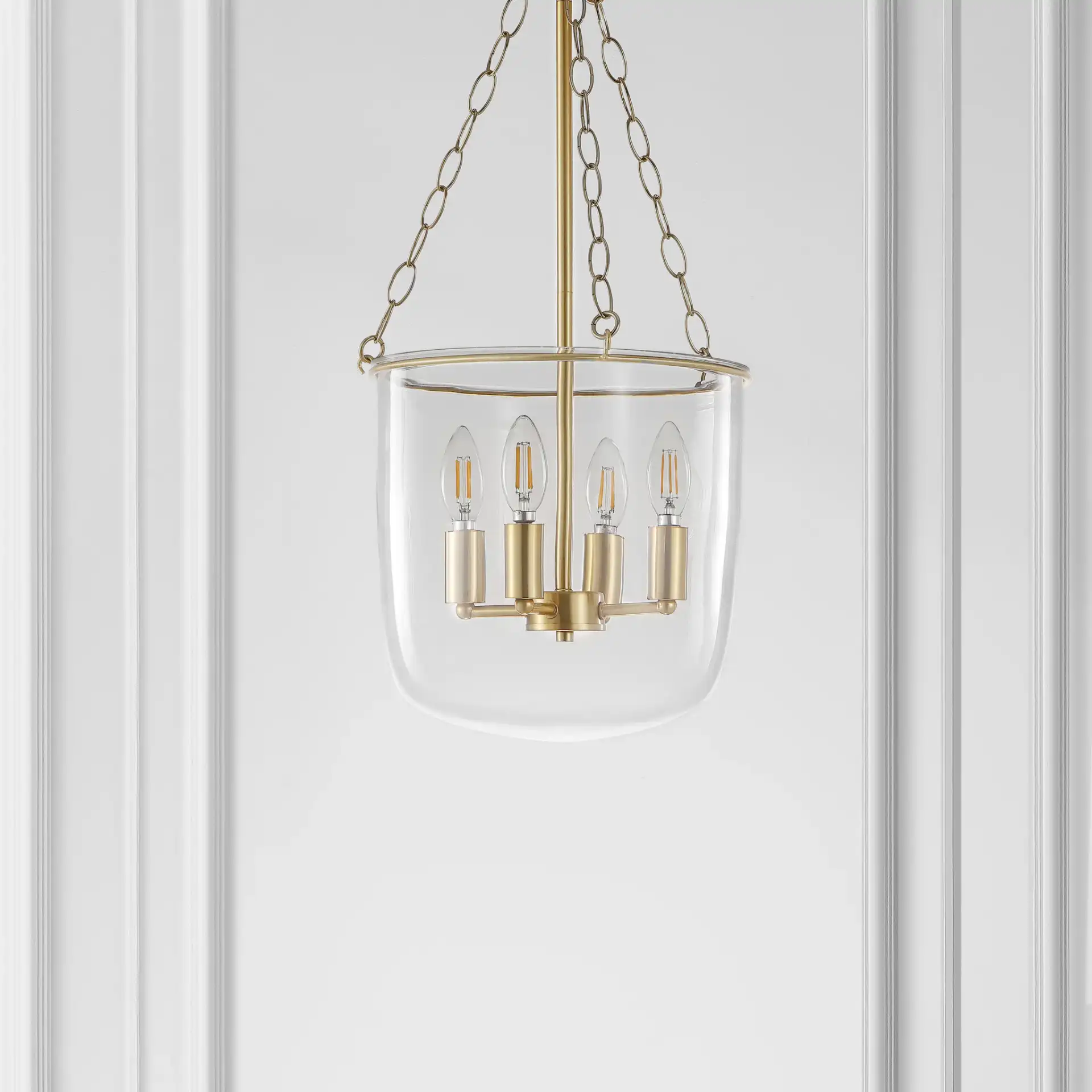 Dahye Four-Light Pendant in Clear / Brass in a styled room