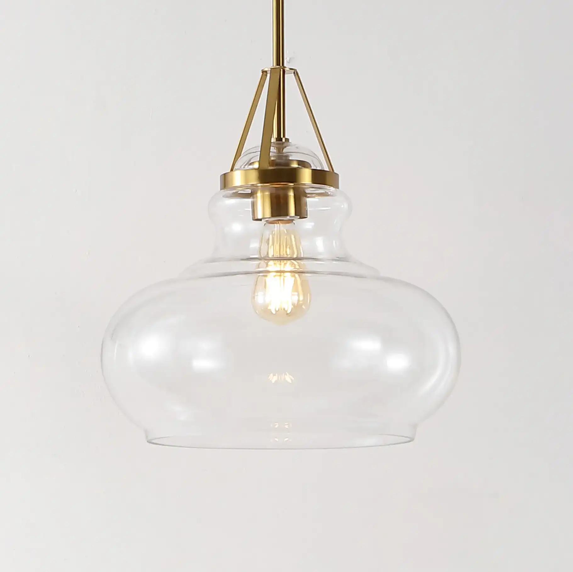 Salud Pendant in Brass / Clear in a styled room
