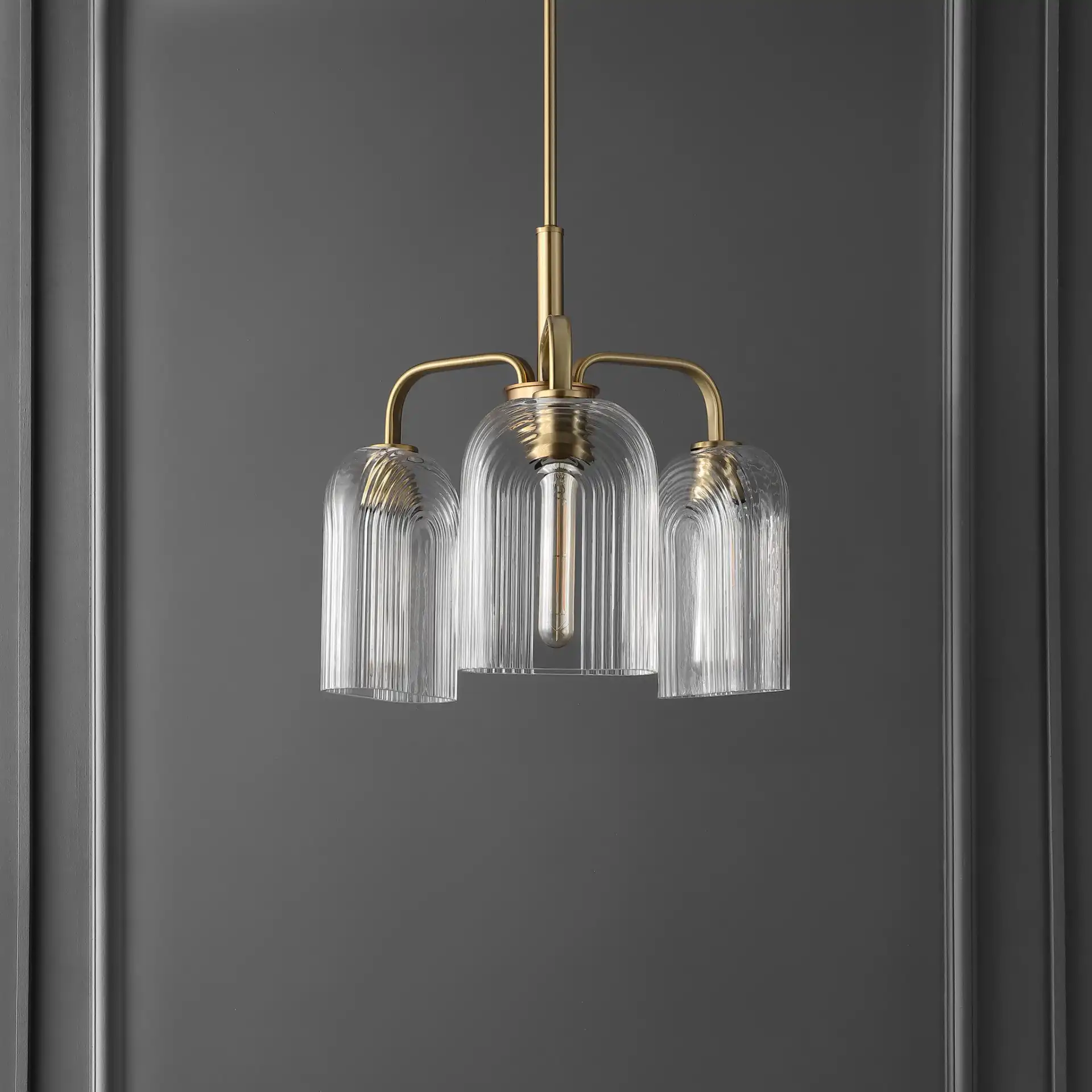 Romeyn Three-Light Pendant in Brass in a styled room