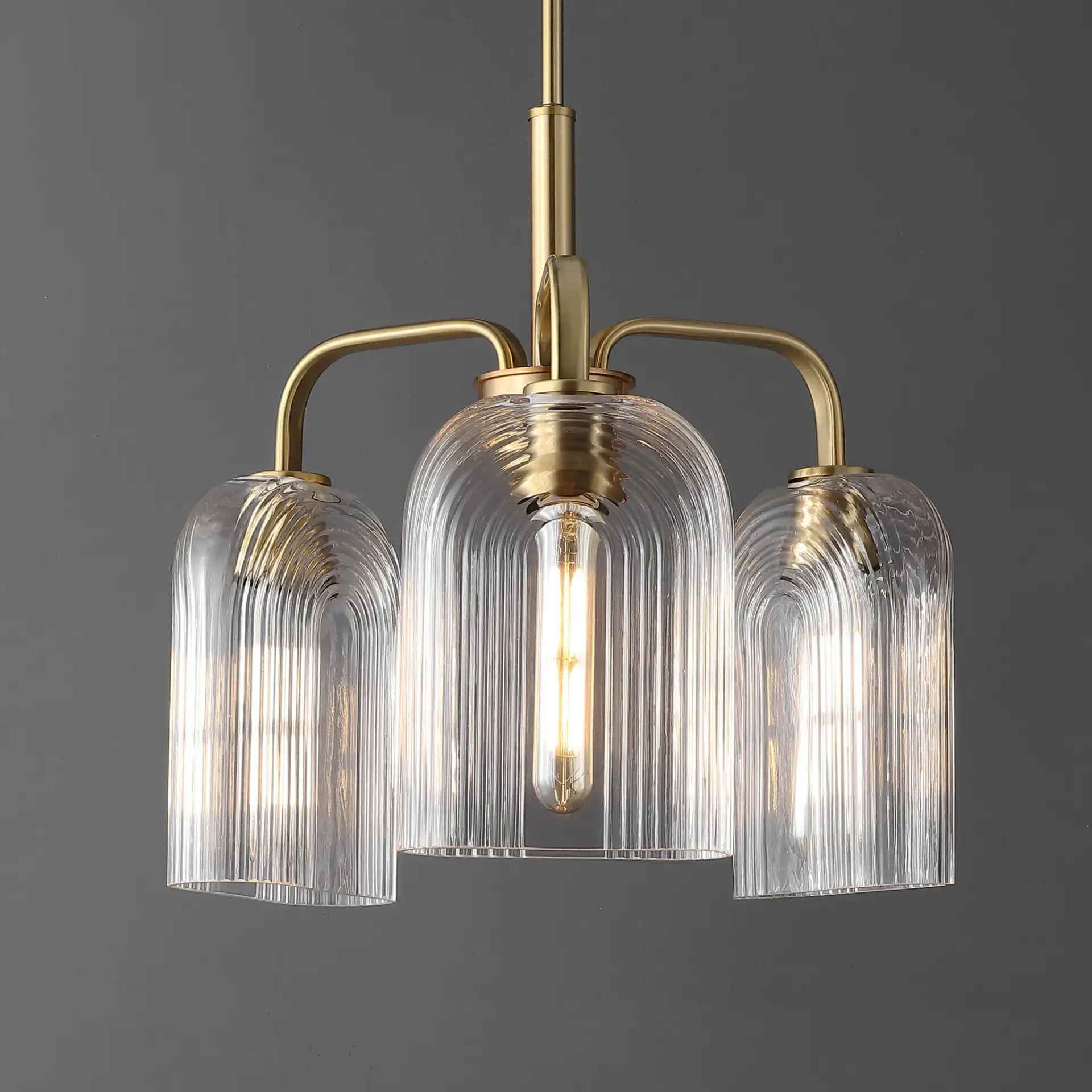 Romeyn Three-Light Pendant in Brass in a styled room