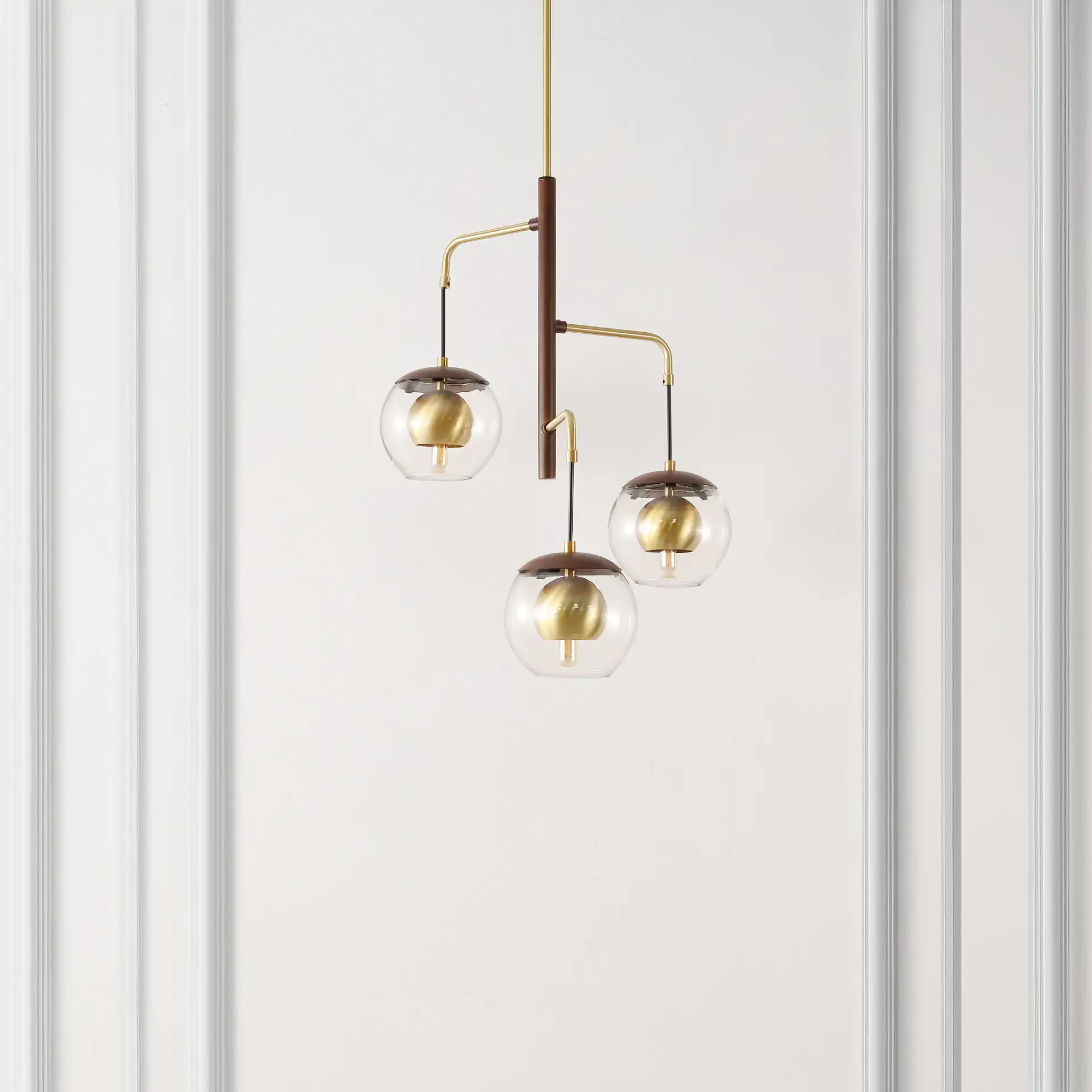 Vylora Three-Light Pendant in Dark Walnut / Brass in a styled room