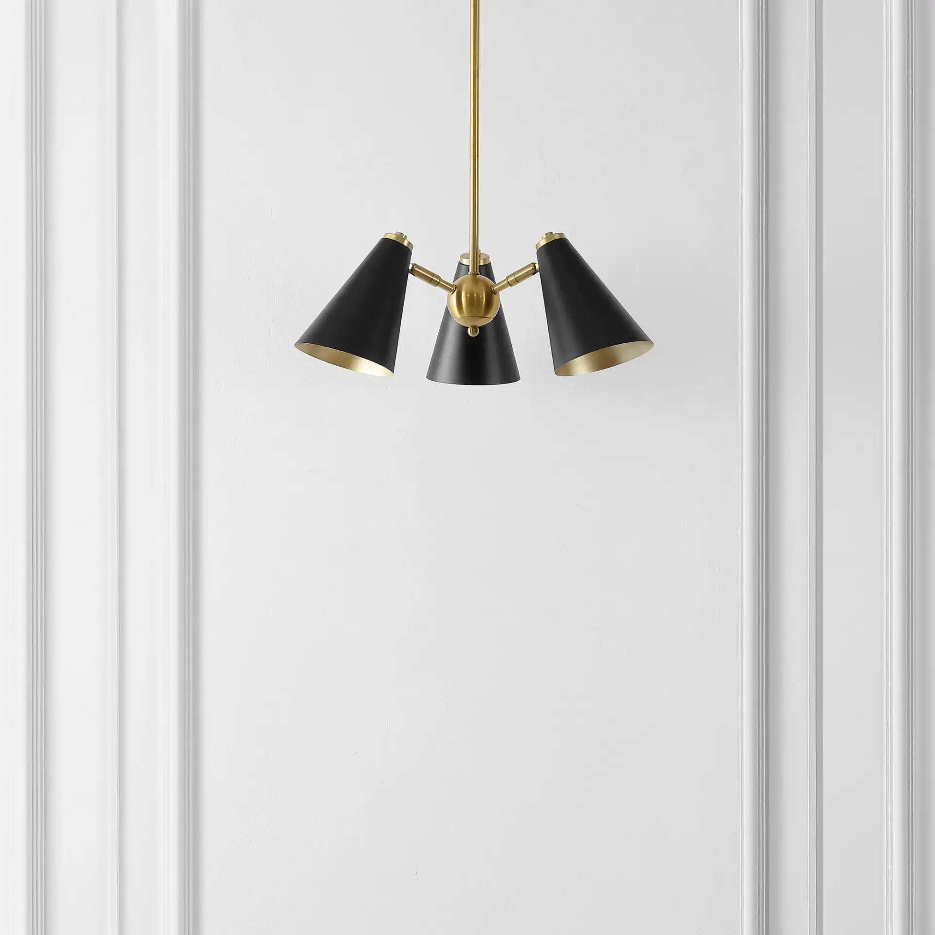Naveeda Three-Light Pendant in Black / Brass in a styled room
