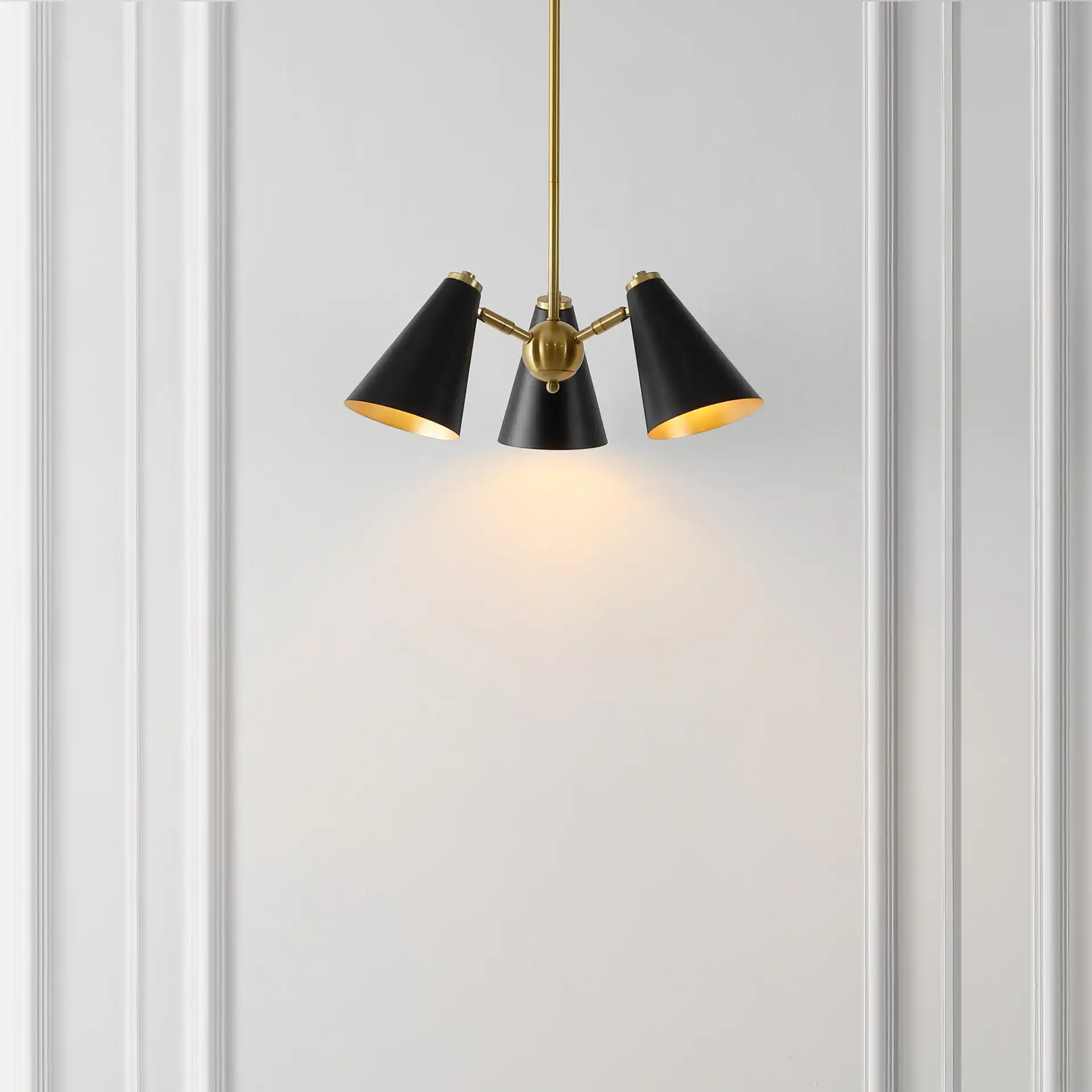 Naveeda Three-Light Pendant in Black / Brass in a styled room