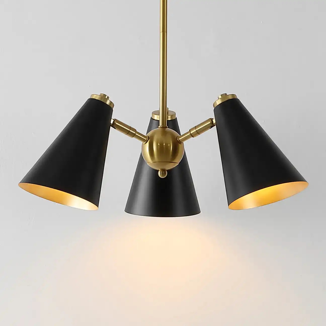 Naveeda Three-Light Pendant in Black / Brass in a styled room
