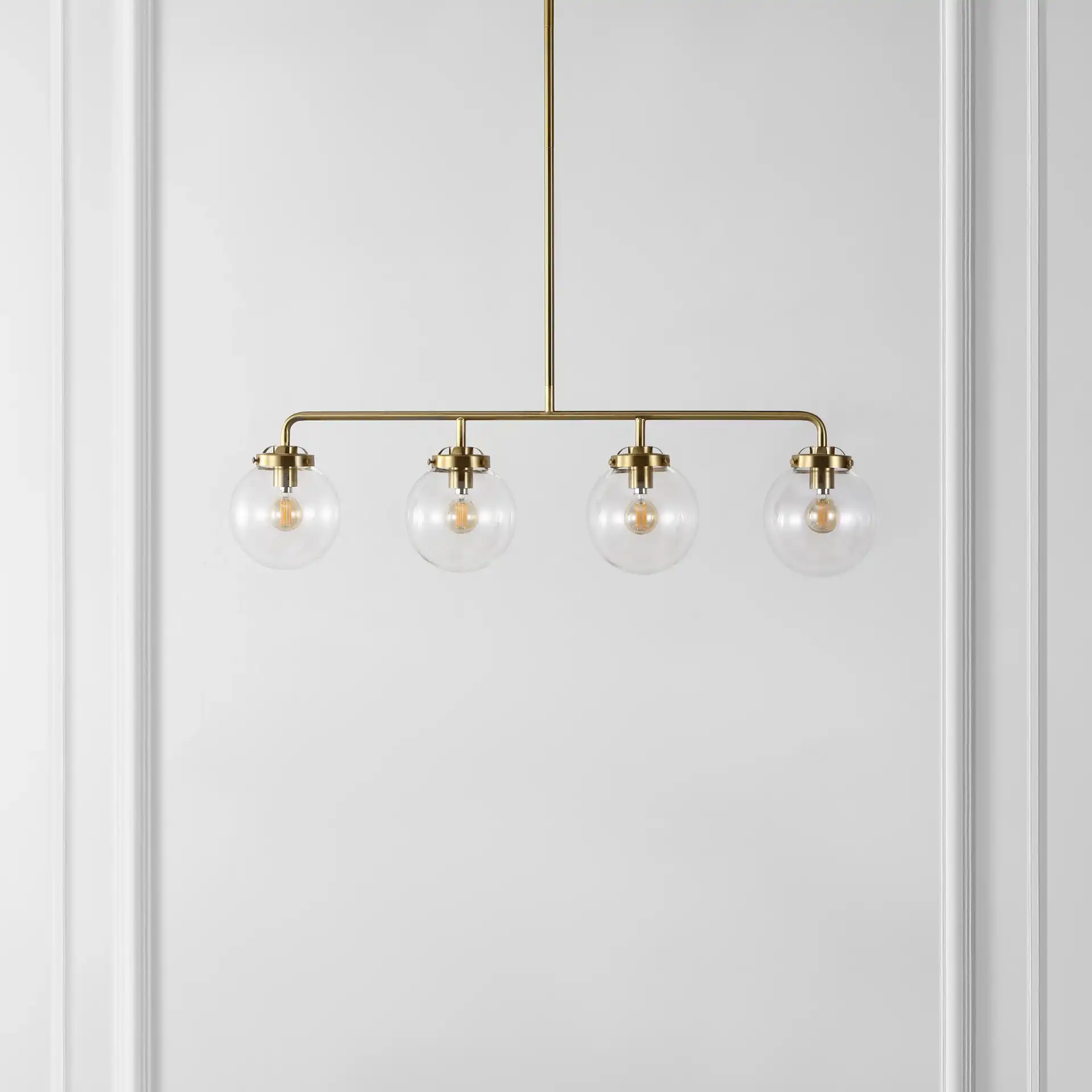 Markle Four-Light Pendant in Brass in a styled room