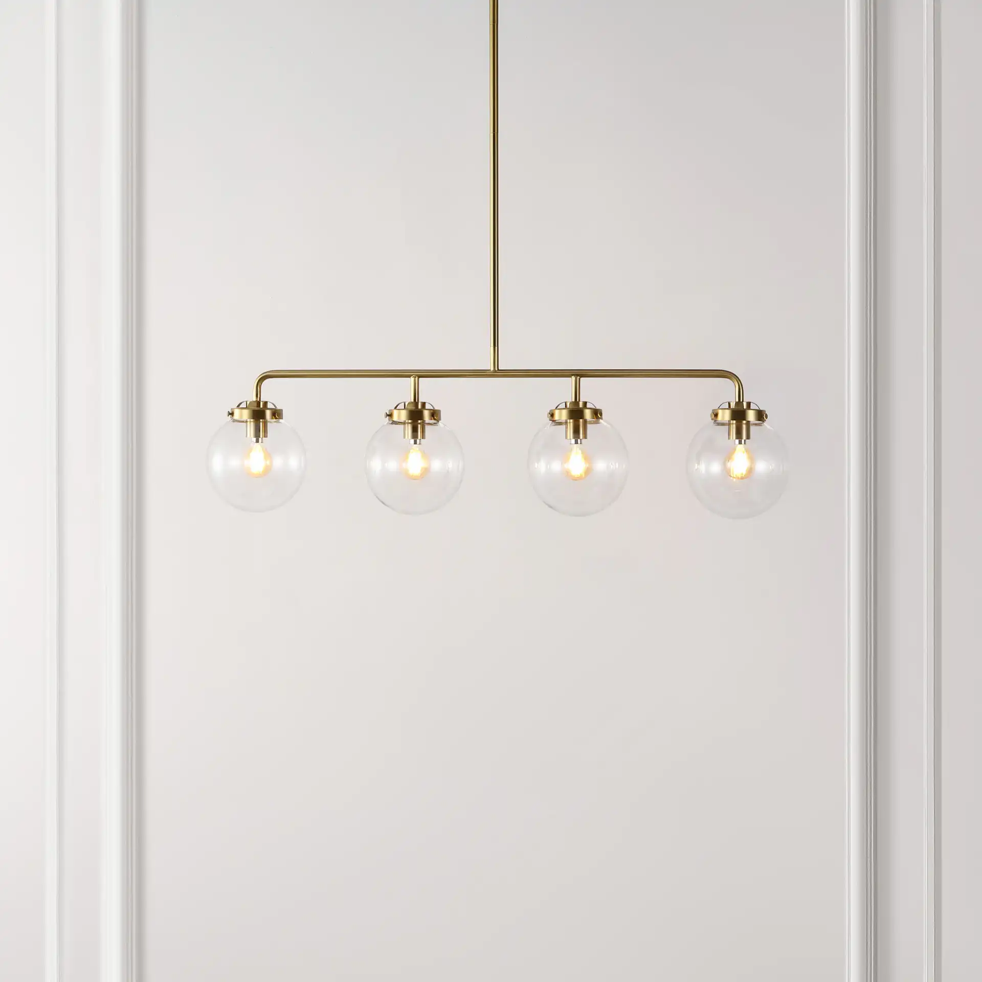 Markle Four-Light Pendant in Brass in a styled room