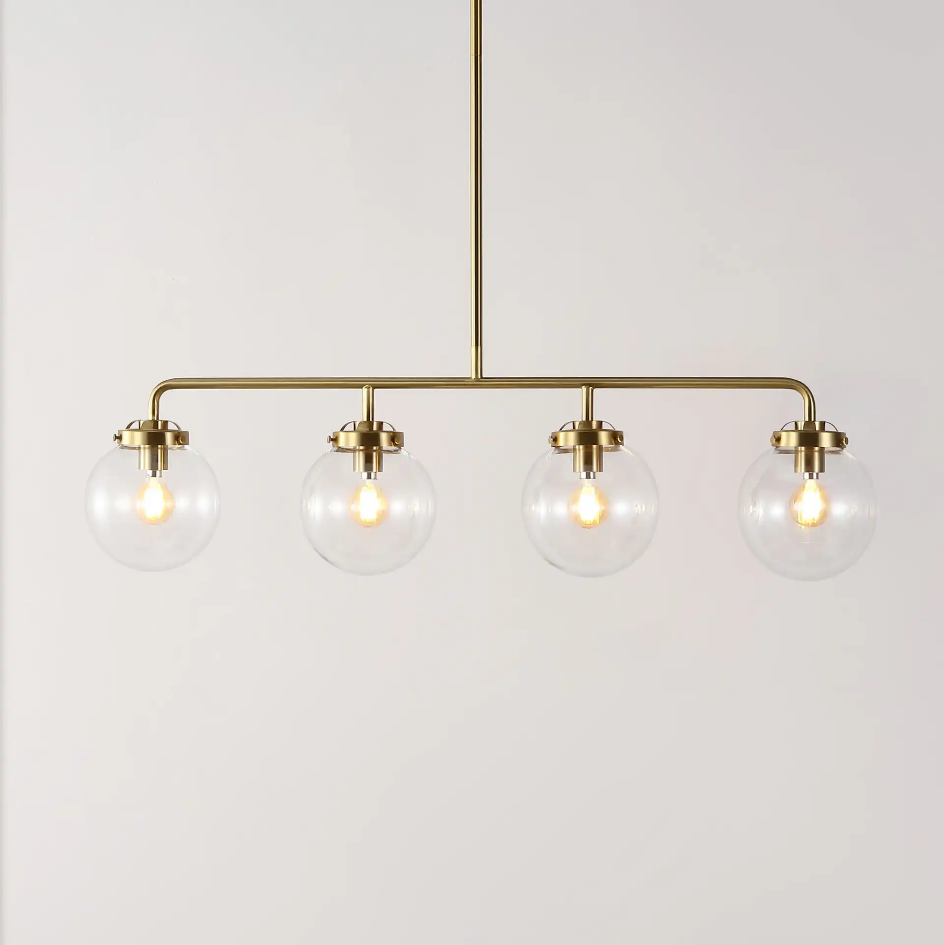 Markle Four-Light Pendant in Brass in a styled room