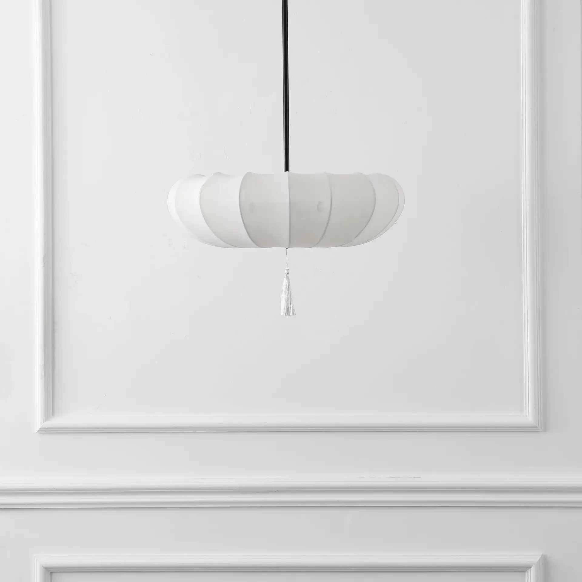 Amelie Three-Light Pendant in Cream / Black in a styled room