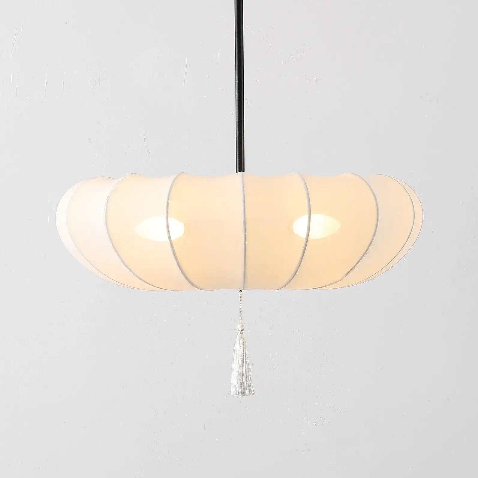 Amelie Three-Light Pendant in Cream / Black in a styled room