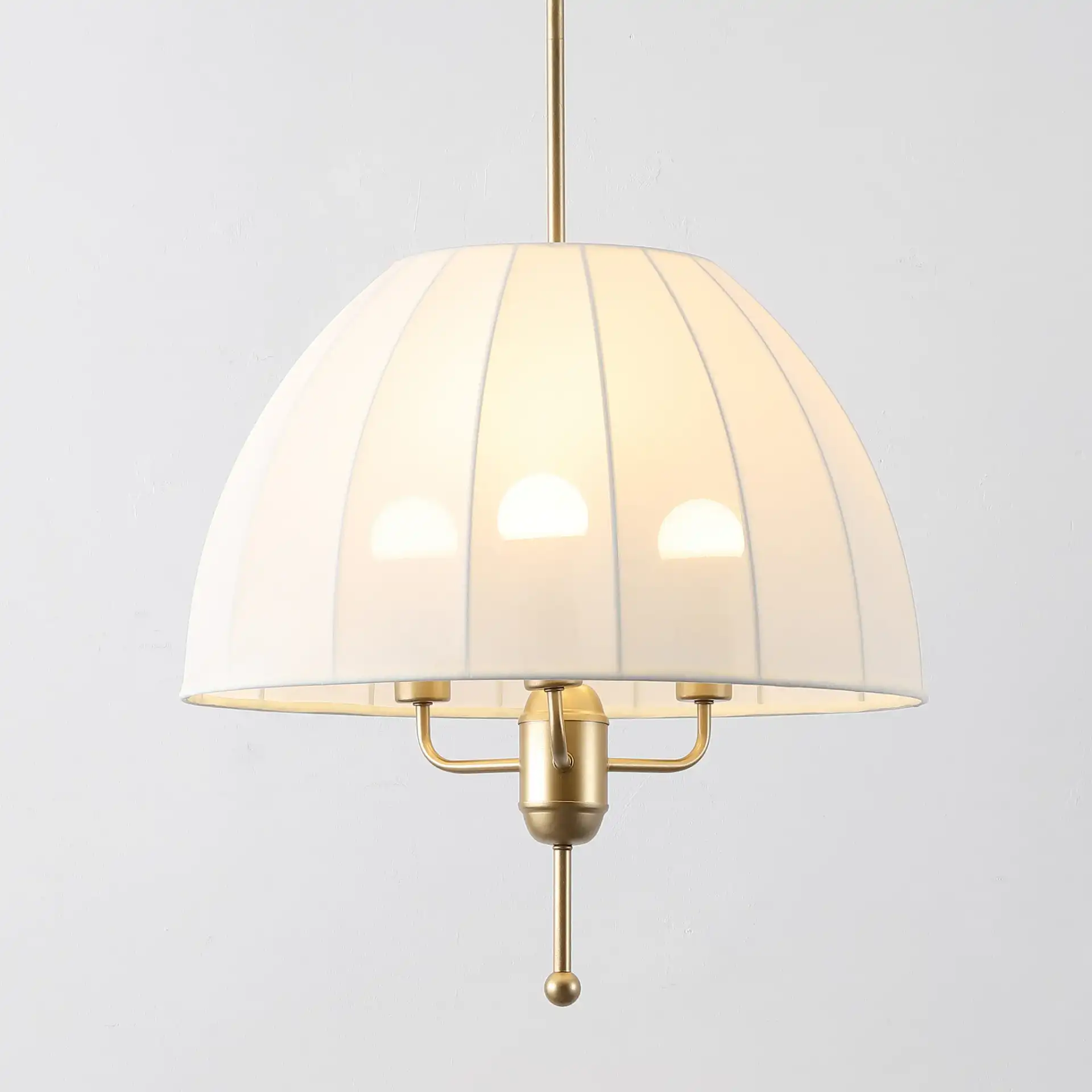Silvie Three-Light Pendant in Cream / Gold in a styled room