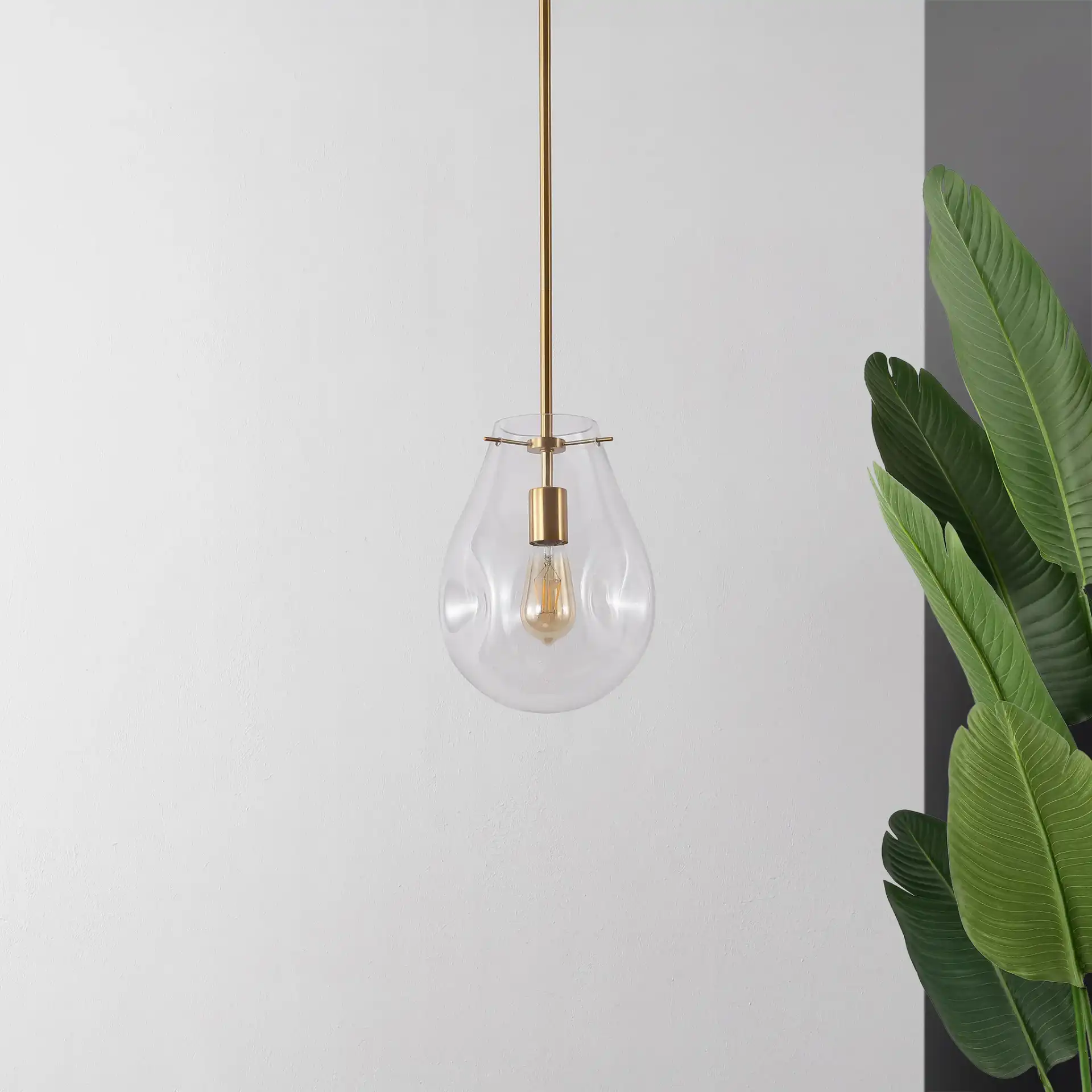Elery Pendant in Clear / Brass in a styled room