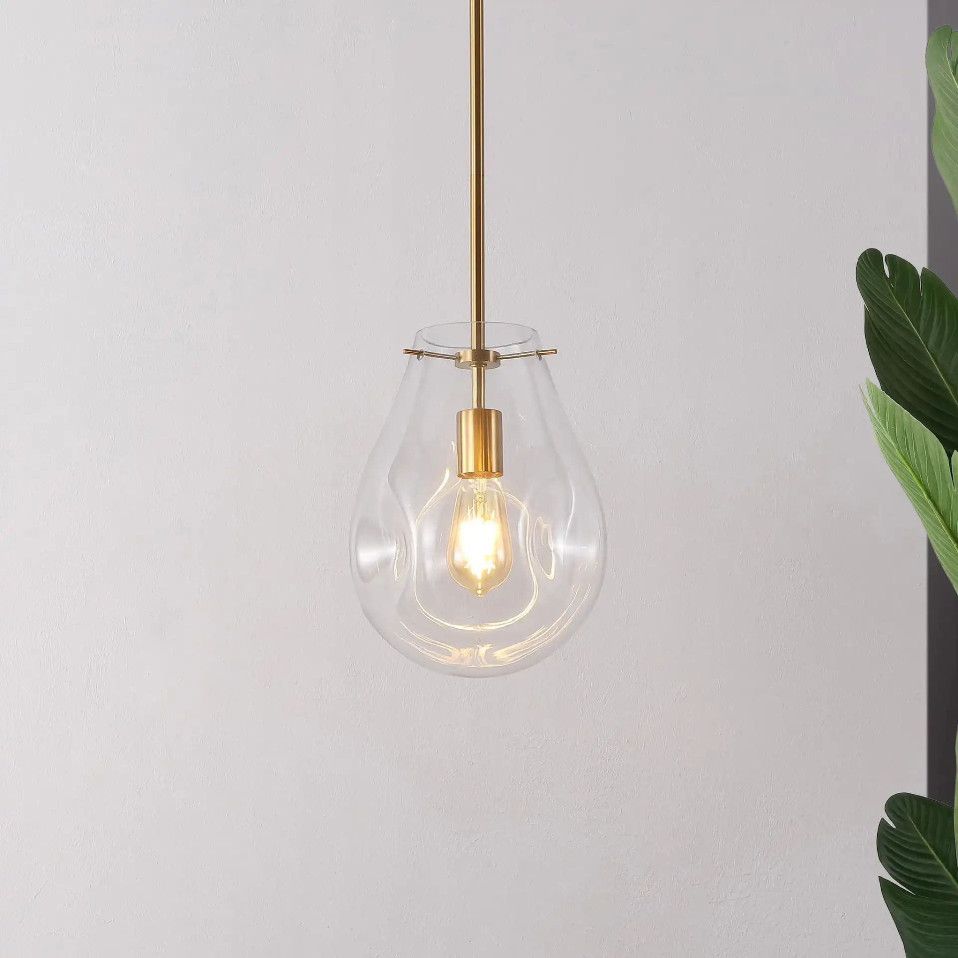 Elery Pendant in Clear / Brass in a styled room