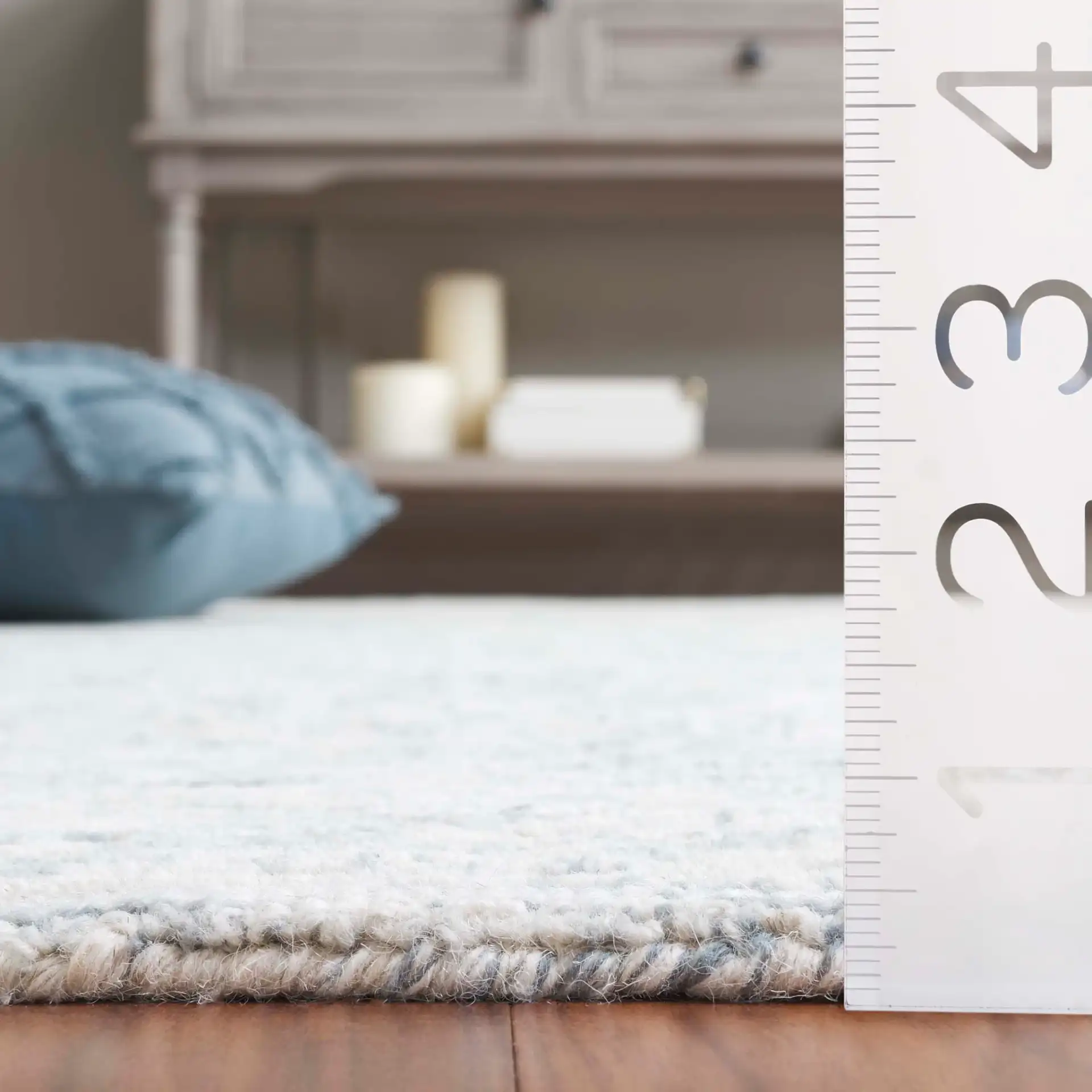 Pine Bordered Hand-Tufted Wool Rug in Light Blue / Ivory in a styled room