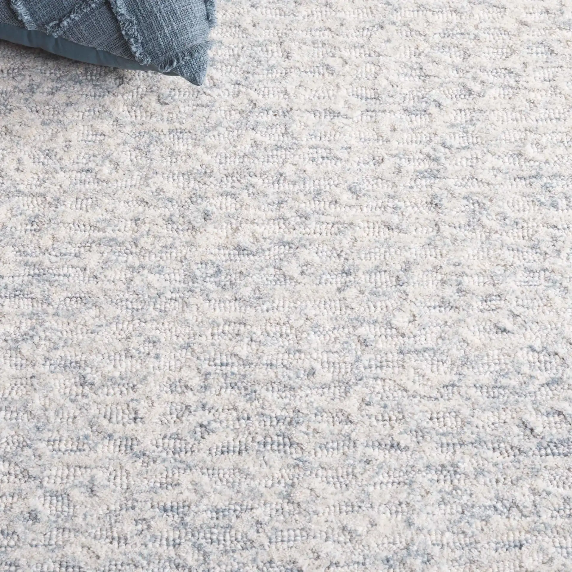 Pine Bordered Hand-Tufted Wool Rug in Light Blue / Ivory in a styled room