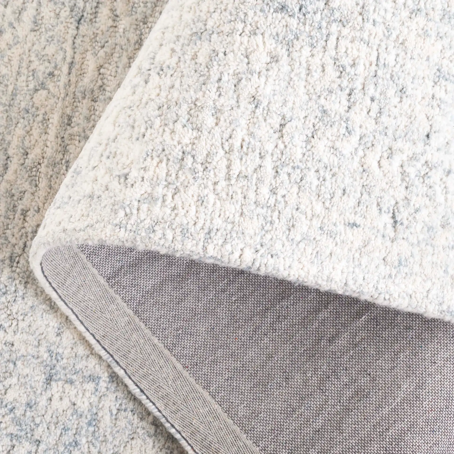 Pine Bordered Hand-Tufted Wool Rug in Light Blue / Ivory in a styled room