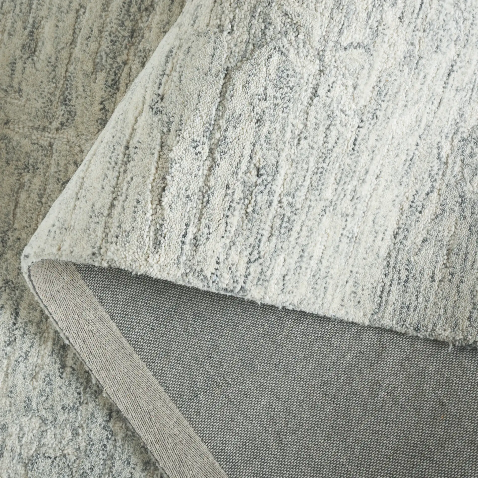 Pine Striated Linear Hand-Tufted Wool Rug in Gray in a styled room