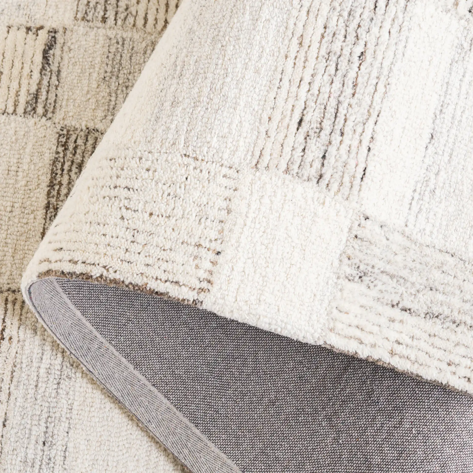 Pine Checkerboard Hand-Tufted Wool Rug in Beige / Brown in a styled room