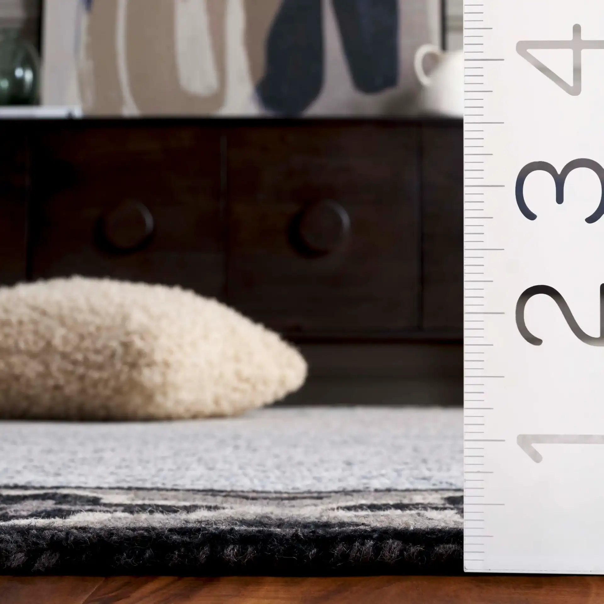 Pine Bordered Geometric Hand-Tufted Wool Rug in Charcoal / Ivory in a styled room