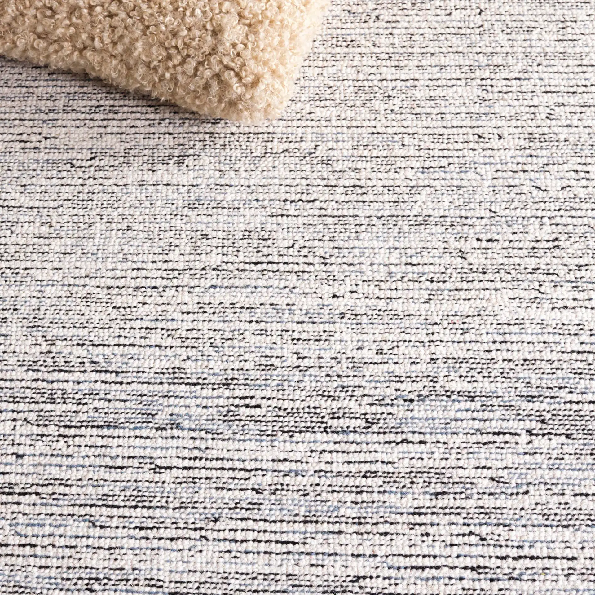 Pine Bordered Geometric Hand-Tufted Wool Rug in Charcoal / Ivory in a styled room