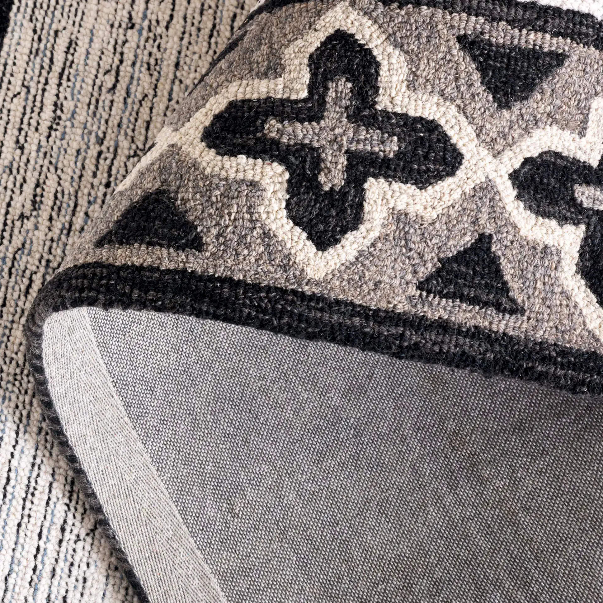 Pine Bordered Geometric Hand-Tufted Wool Rug in Charcoal / Ivory in a styled room