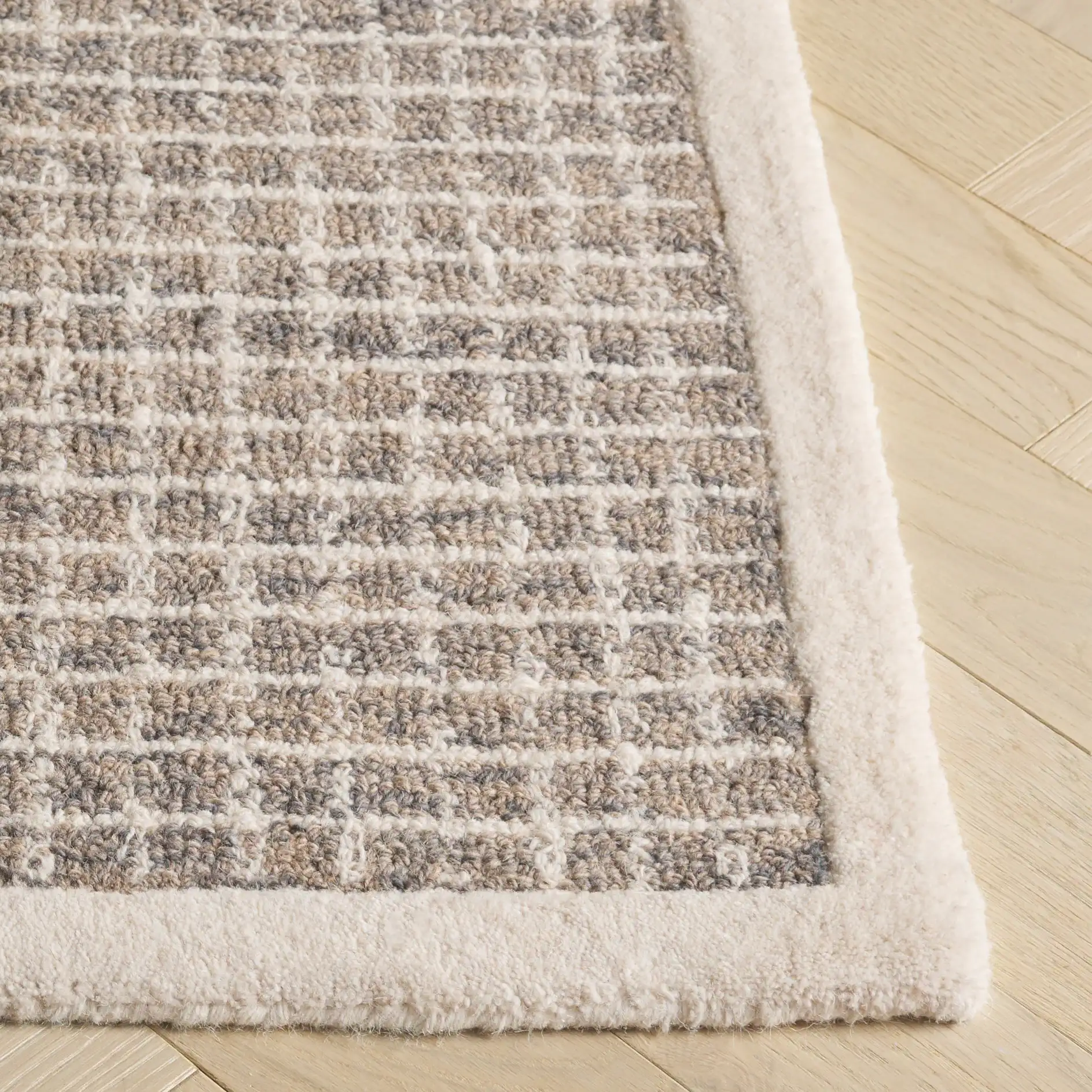 Pine Bordered Grid Hand-Tufted Wool Rug in Gray / Ivory in a styled room
