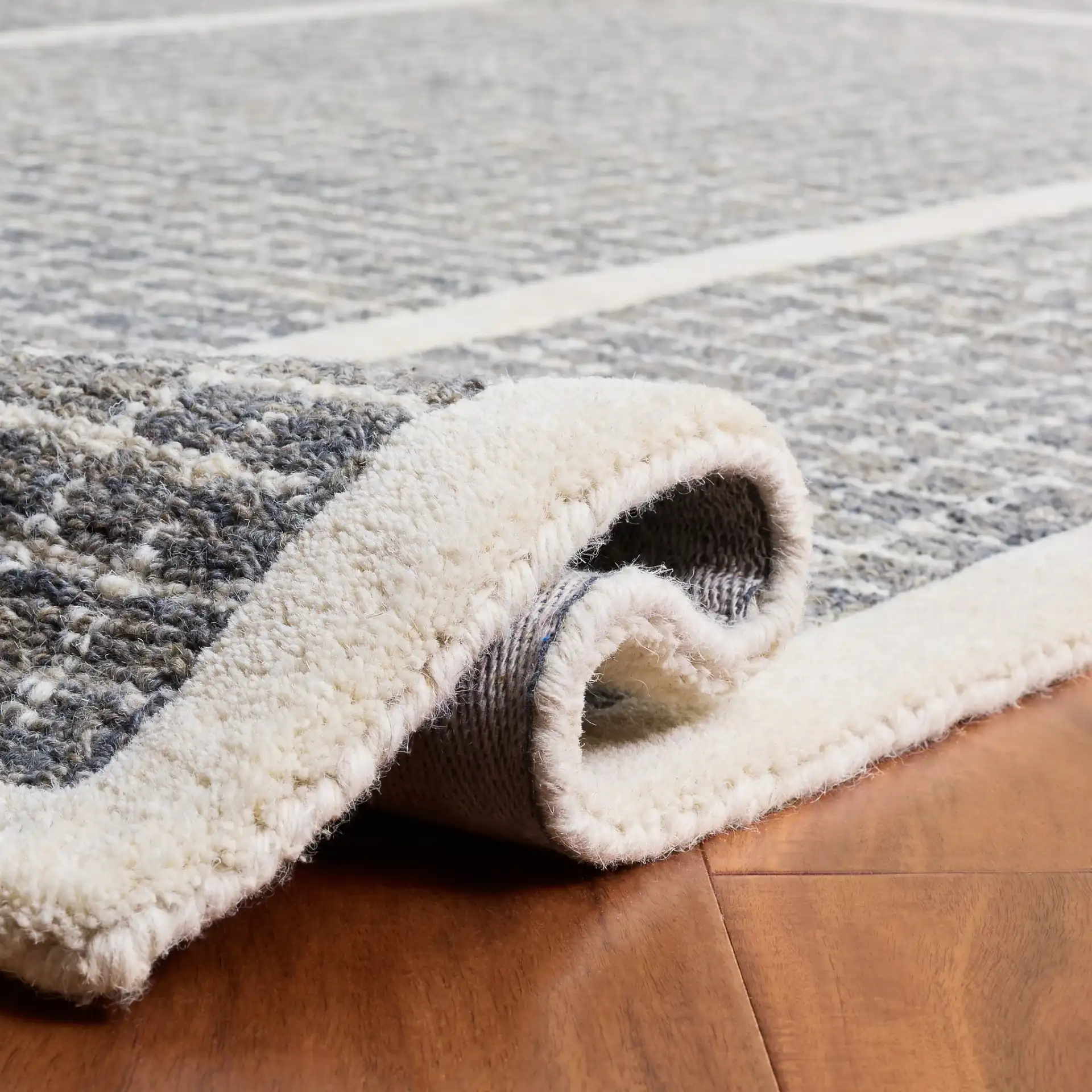 Pine Bordered Grid Hand-Tufted Wool Rug in Gray / Ivory in a styled room