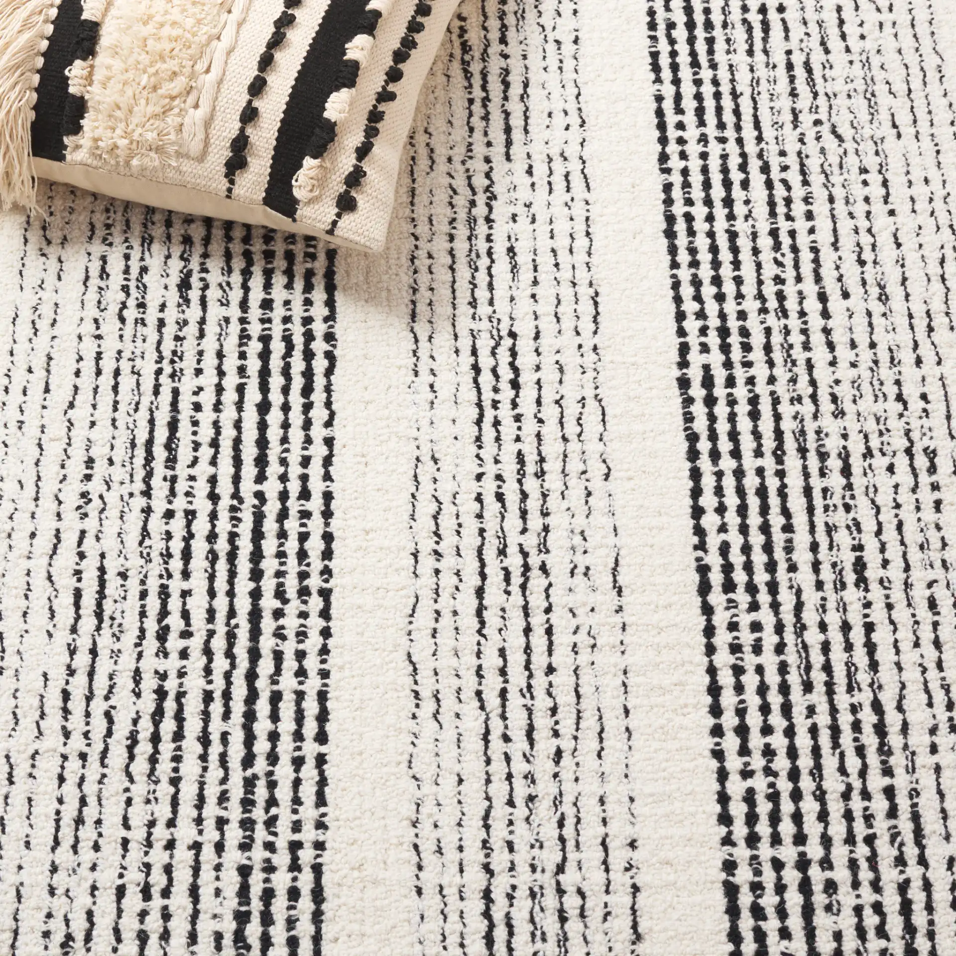 Pine Concentric Frame Hand-Tufted Wool Rug in Black / Ivory in a styled room