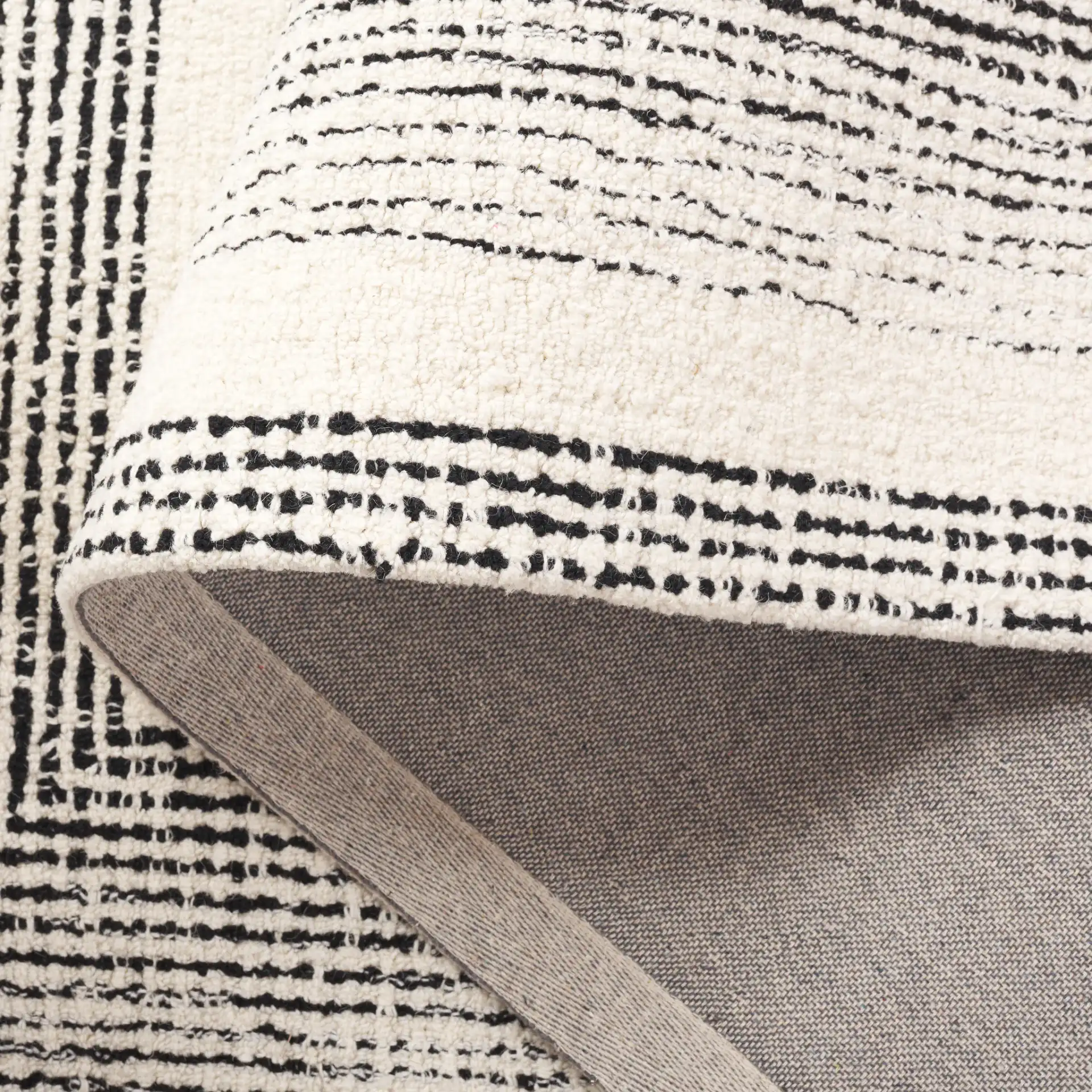 Pine Concentric Frame Hand-Tufted Wool Rug in Black / Ivory in a styled room