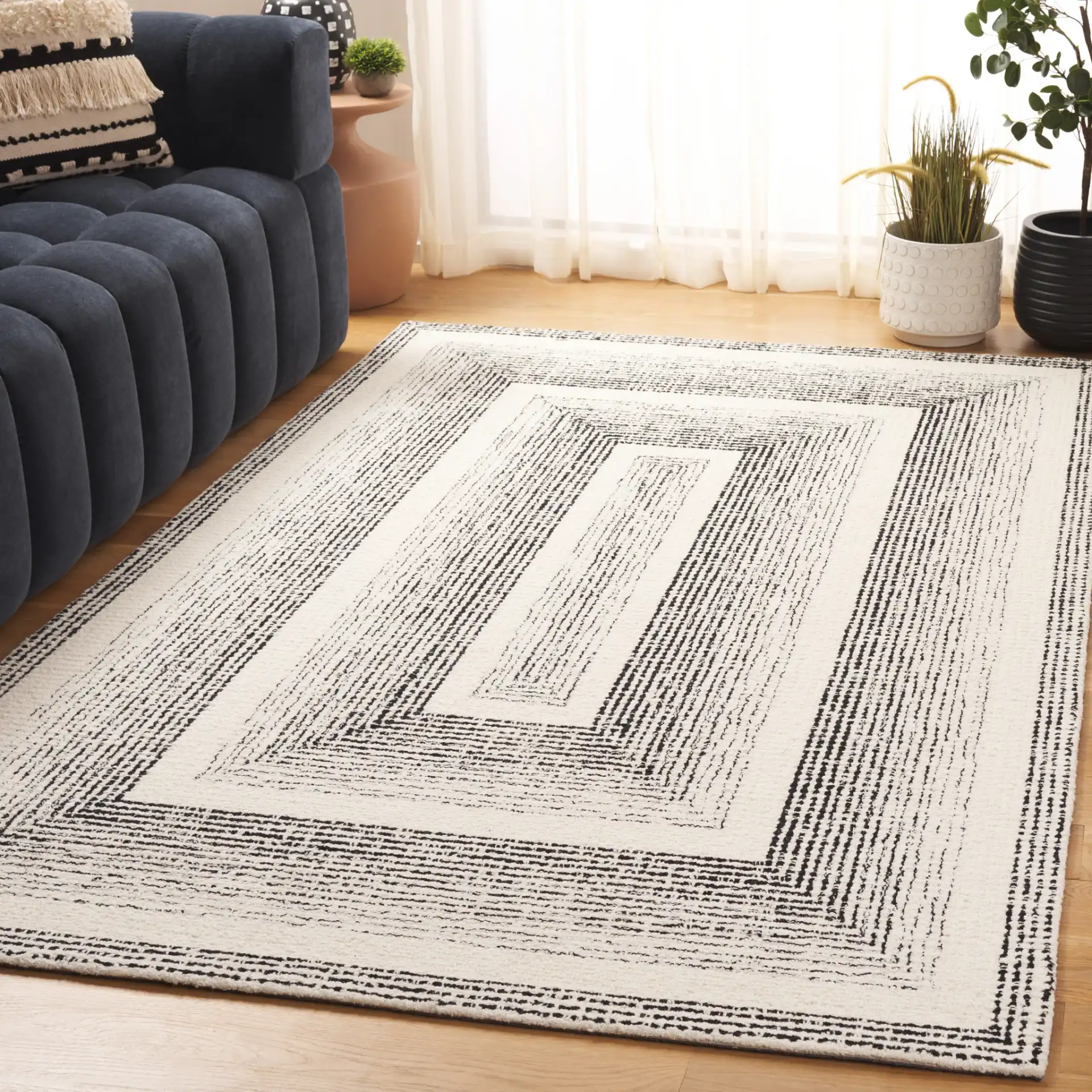 Pine Concentric Frame Hand-Tufted Wool Rug in Black / Ivory in a styled room