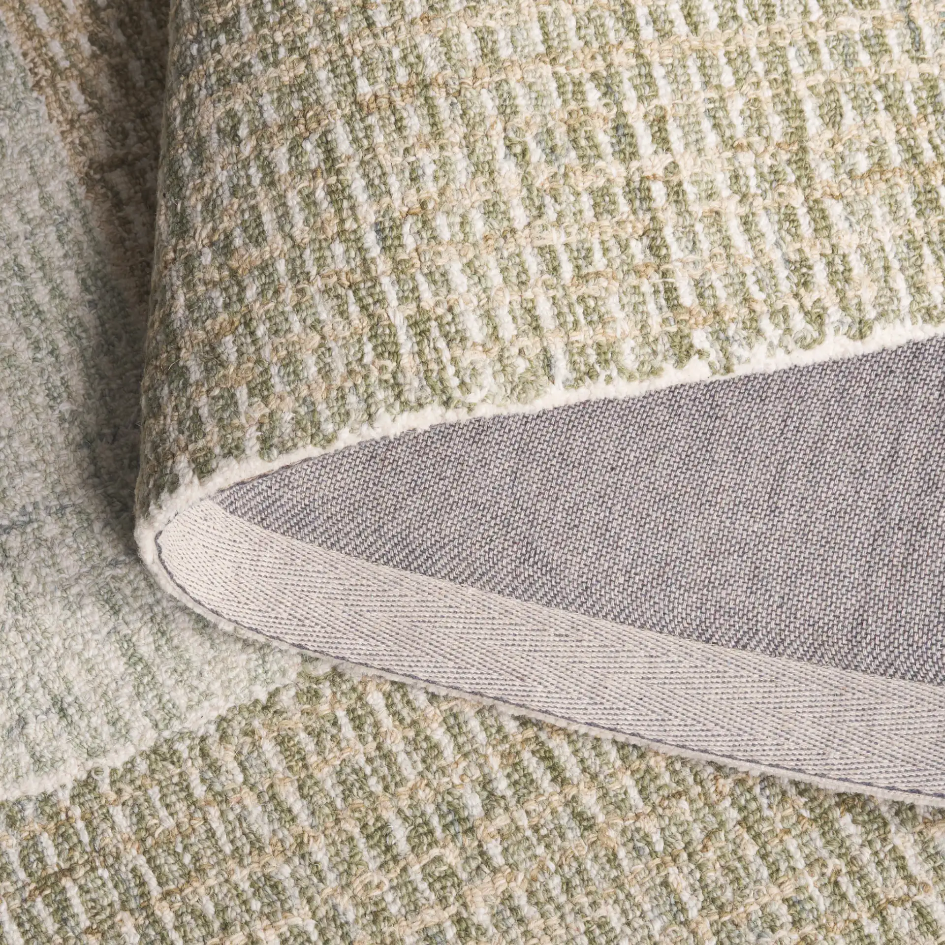 Pine Concentric Border Hand-Tufted Wool Rug in Green / Ivory in a styled room