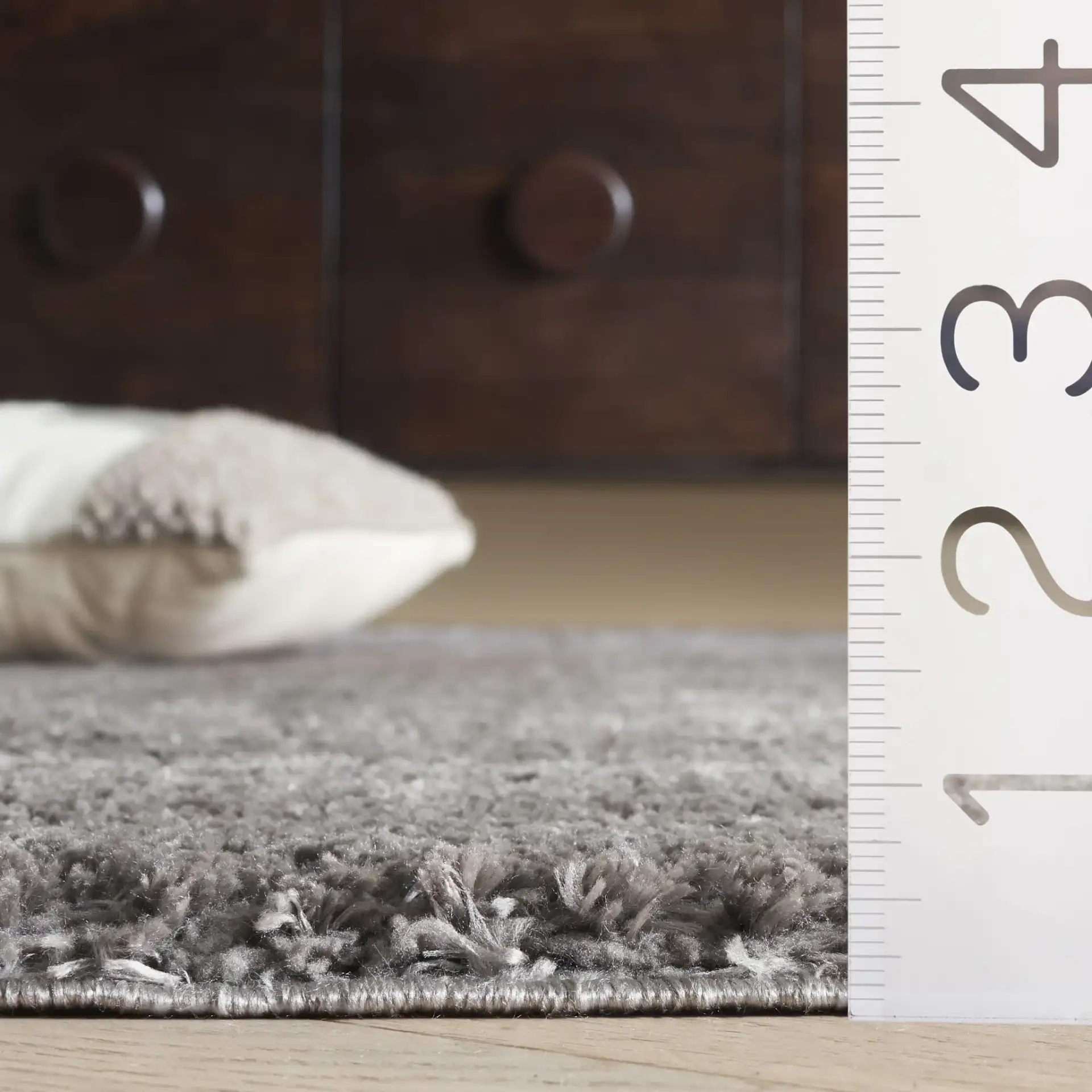 Penelope Textured Solid Shag Rug in Gray in a styled room