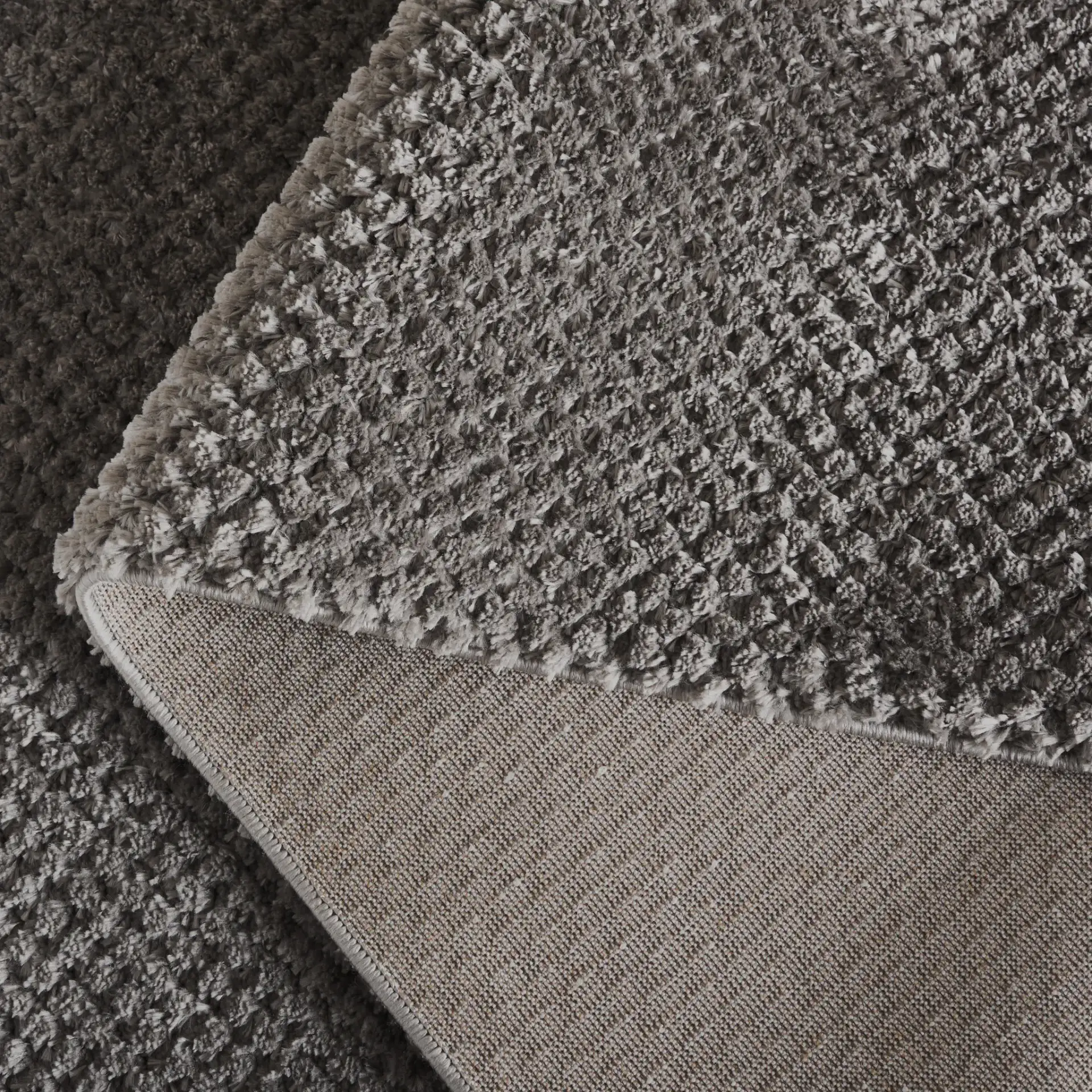 Penelope Textured Solid Shag Rug in Gray in a styled room