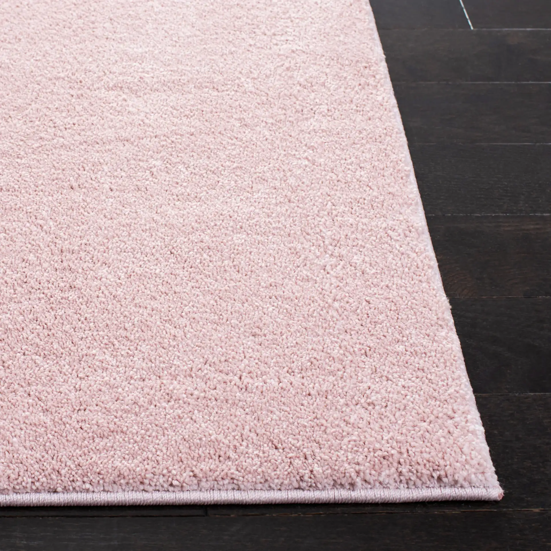 Pattern & Solid Pattern And Solid Textured Solid Rug in Pink in a styled room