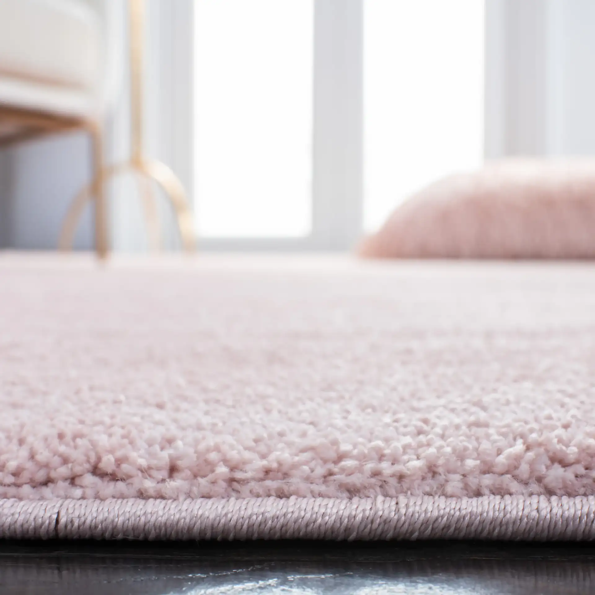 Pattern & Solid Pattern And Solid Textured Solid Rug in Pink in a styled room