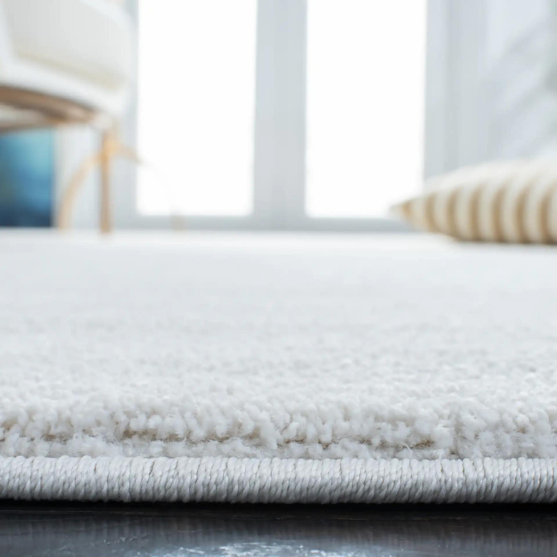 Pattern & Solid Pattern And Solid Textured Solid Rug in Ivory in a styled room
