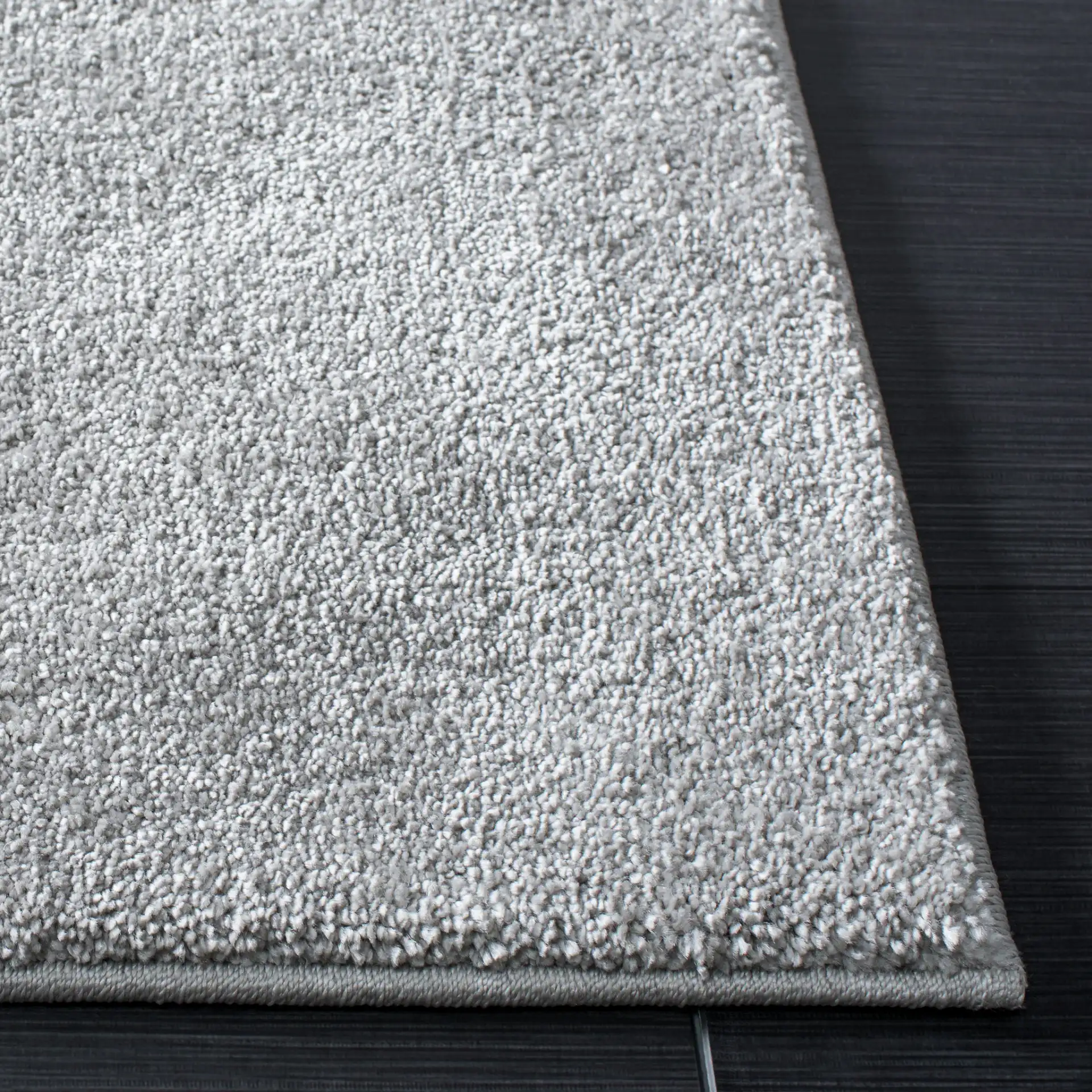 Pattern & Solid Pattern And Solid Textured Solid Rug in Light Gray in a styled room