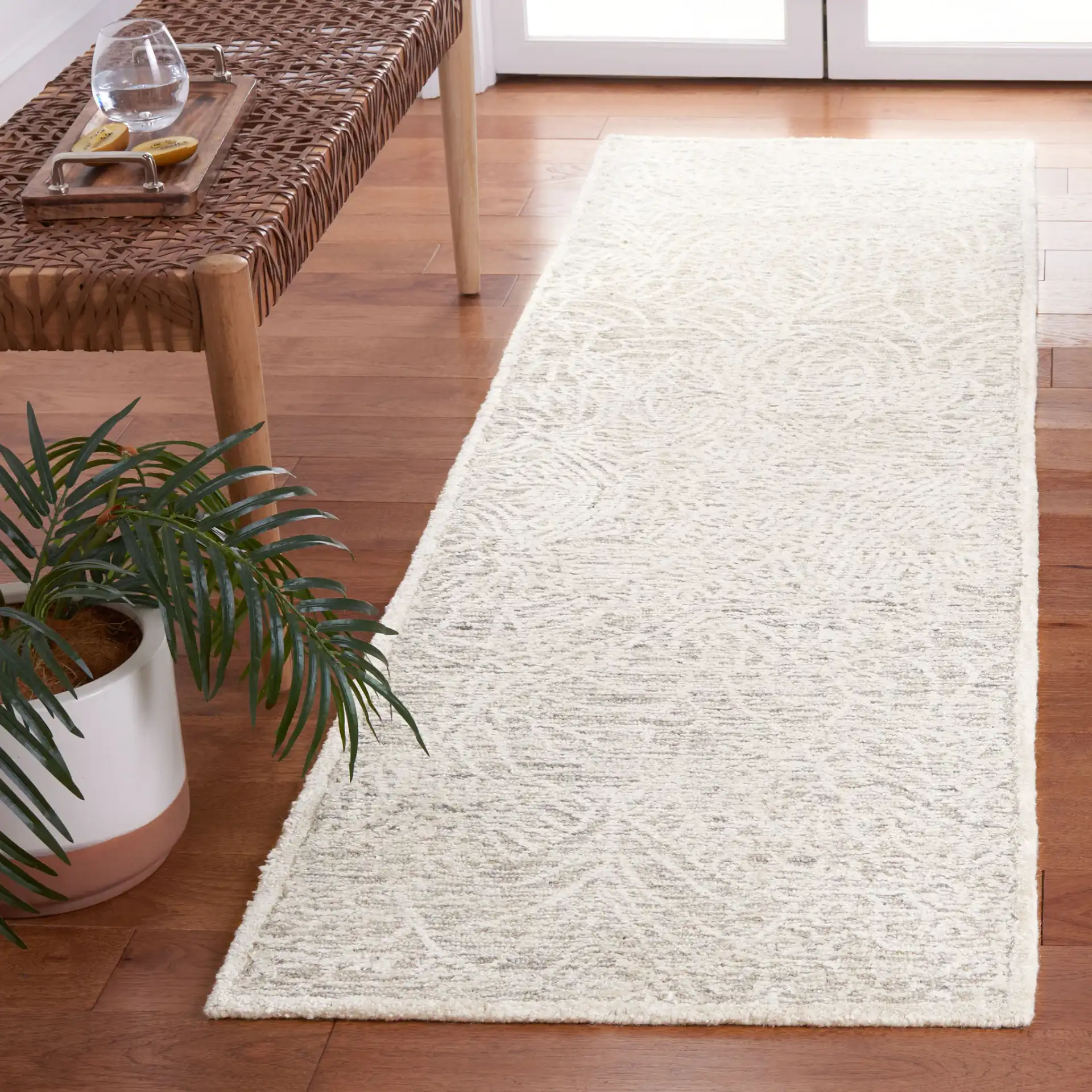 Precious Botanical Vine Hand-Tufted Rug in Gray / Ivory in a styled room